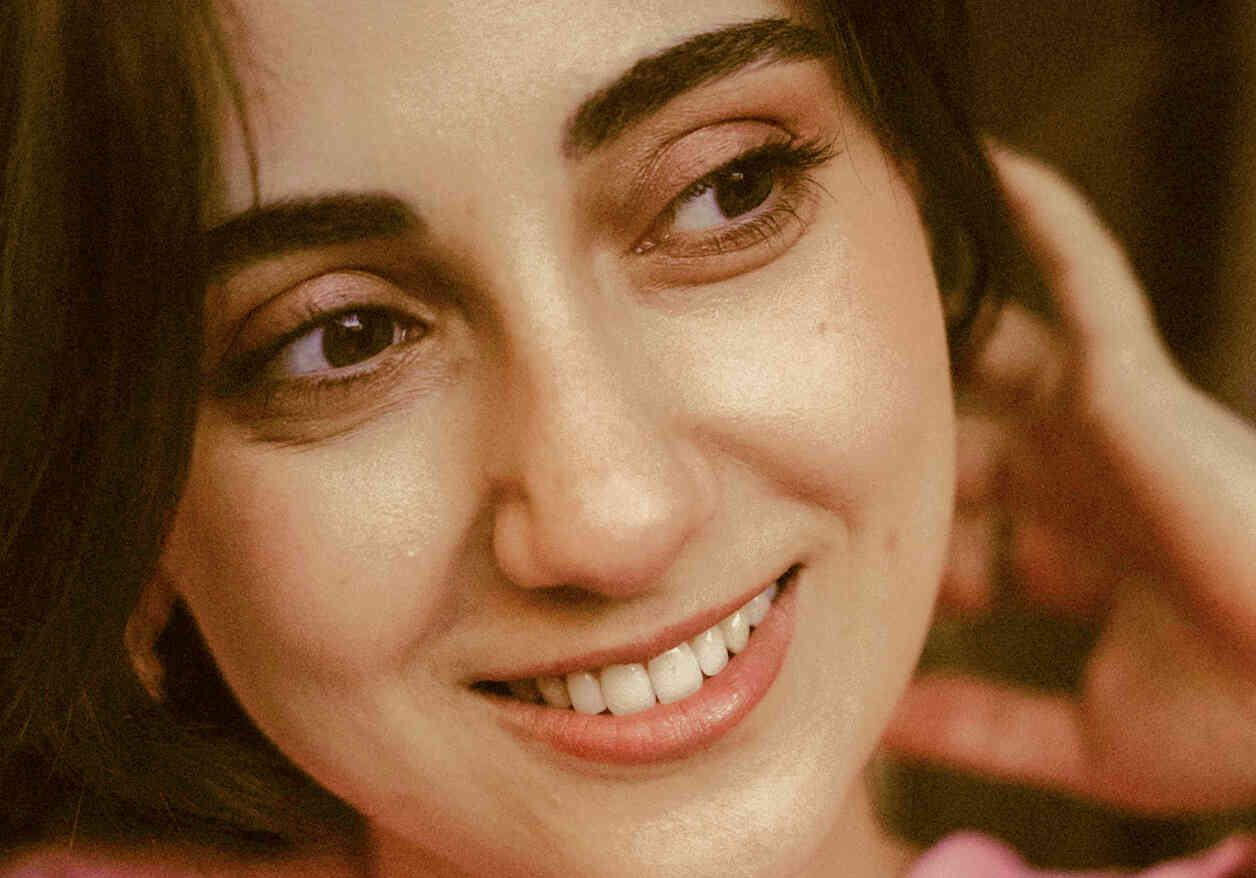 Close-up of a woman smiling warmly.