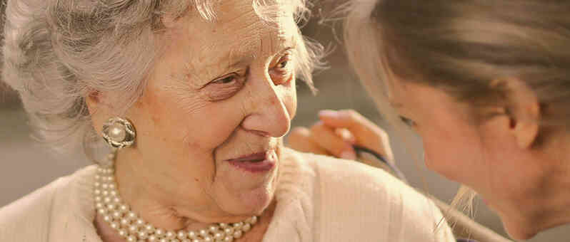 Older woman talking with caregiver.