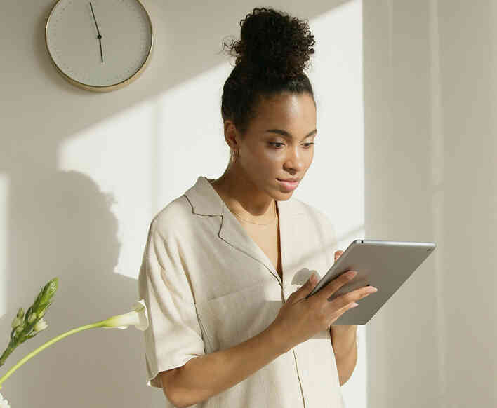 Woman using a tablet at home for online therapy.