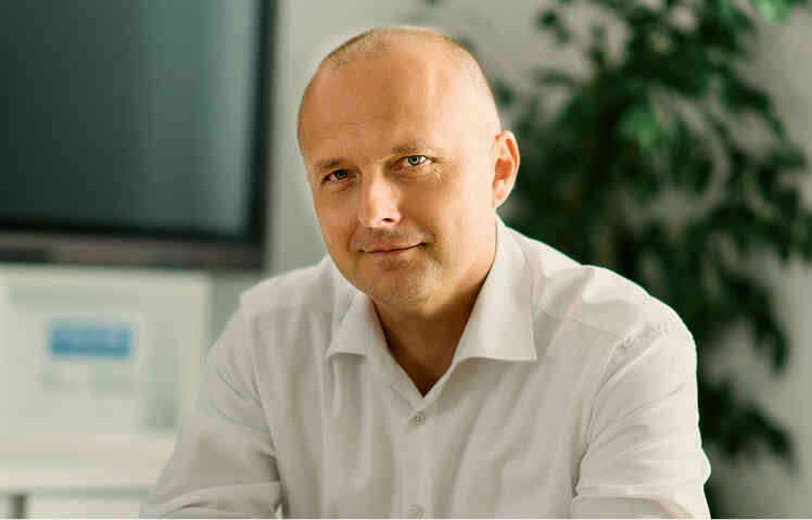 Man sitting in an office looking at the camera.
