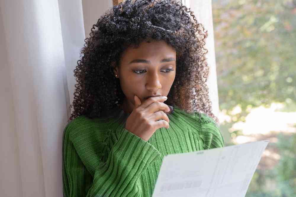 Teen girl reading piece of paper