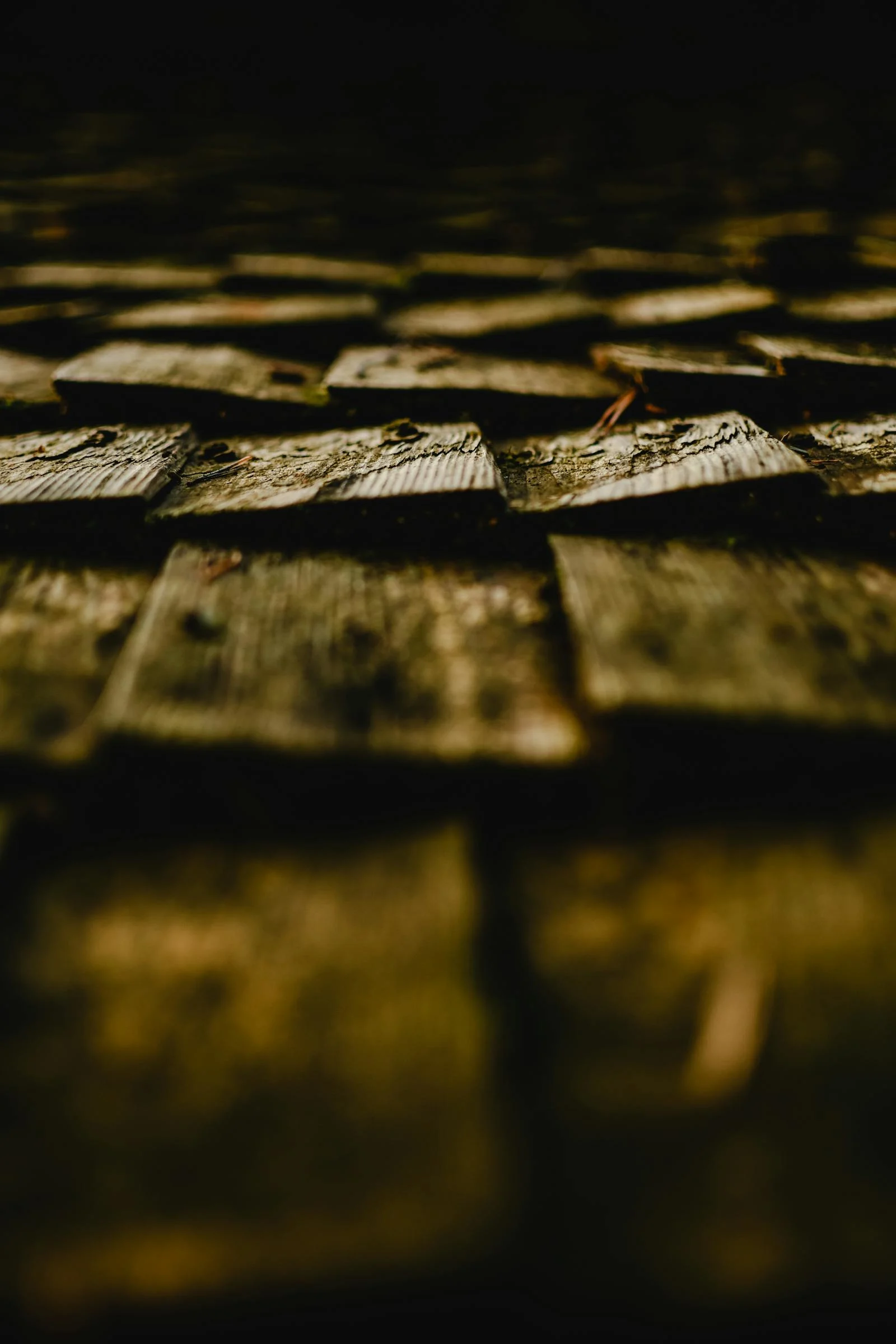 Close view of layered asphalt roof shingles on a residential roof