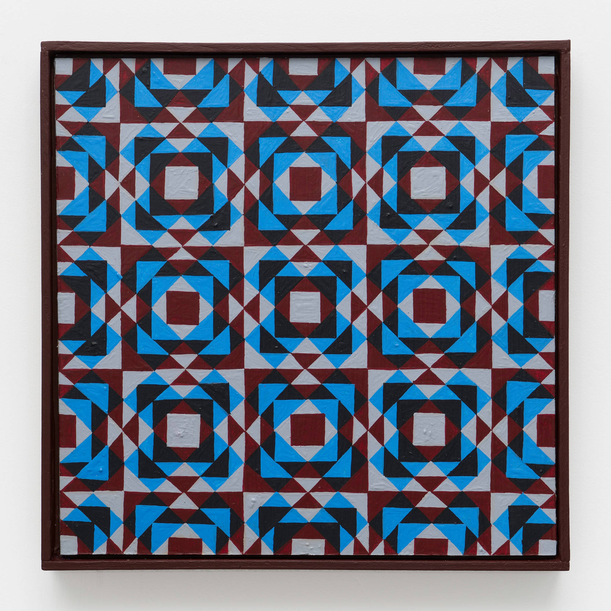 A colorful, symmetrical, geometric painting on board consisting of a pattern of repeating diamonds and triangles of maroon, grey, and blue in a maroon artist frame.