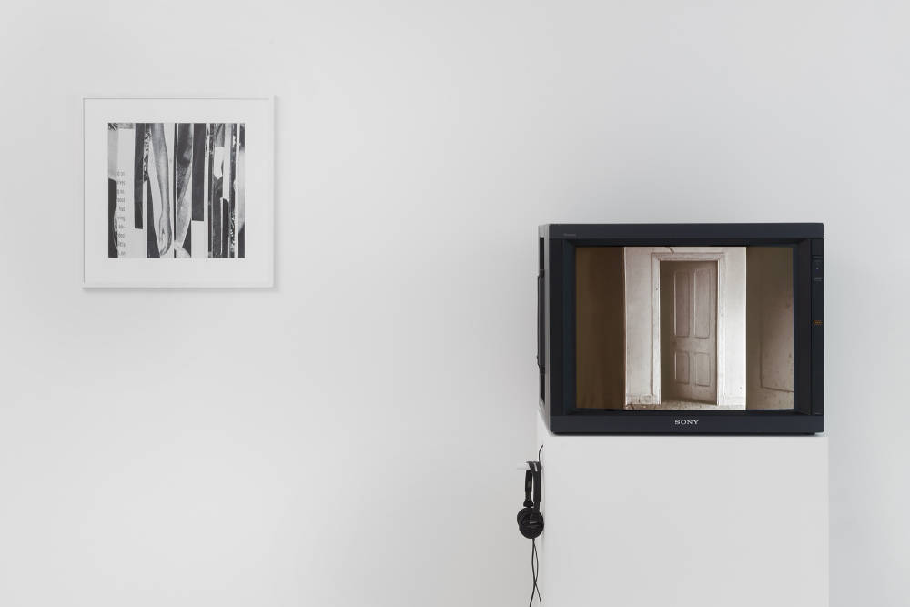 Installation view of Condo London exhibition taking place at Kate MacGarry gallery with several artworks in a white room with gray floors. There is a framed photograph and the left and a television monitor on the right.