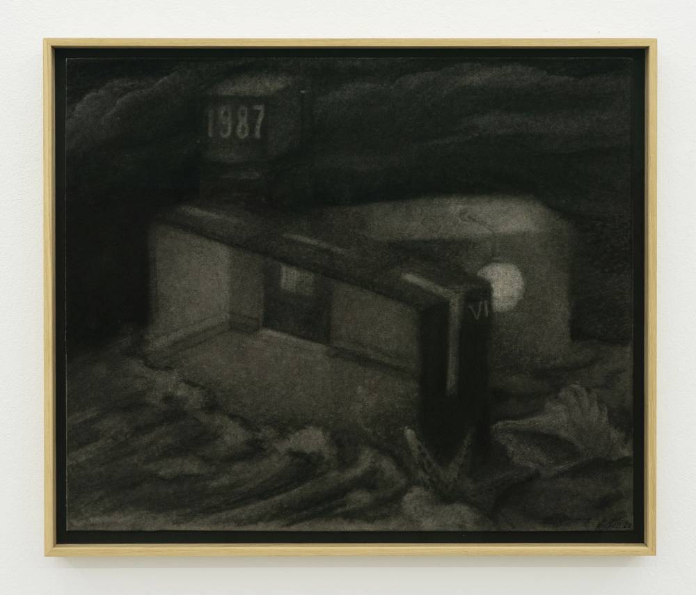 Image of a drawing by Wojciech Bakowski, executed in charcoal on gray board, framed in a blonde wood frame, showing a dream like sequence of large seashells and water on a beach, the waves lapping at the interior structure of a room. Above in the sky is a cube with the date 1987 on it. 