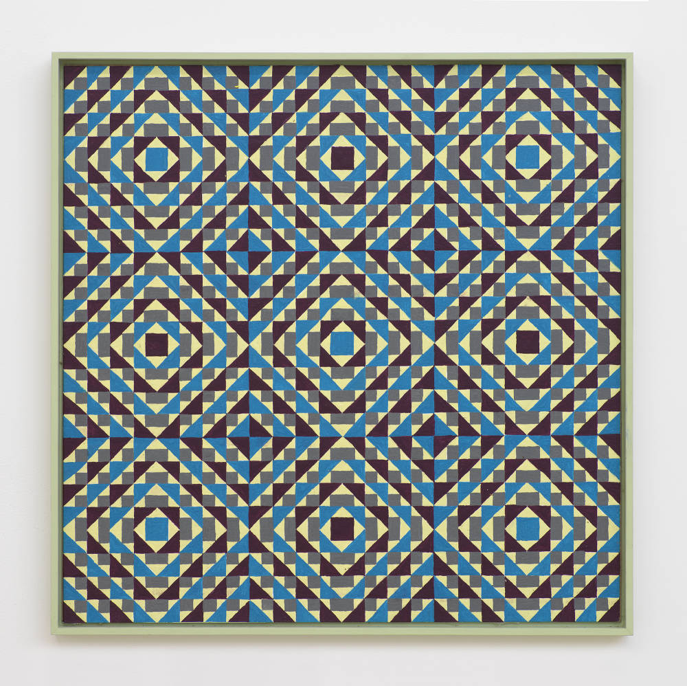 On a white wall a painting depicting a grid of crisscrossing lines generating many rectangles, and triangles. The dominant colors are hues of blue, maroon, and green. The frame is painted a hue of green. 