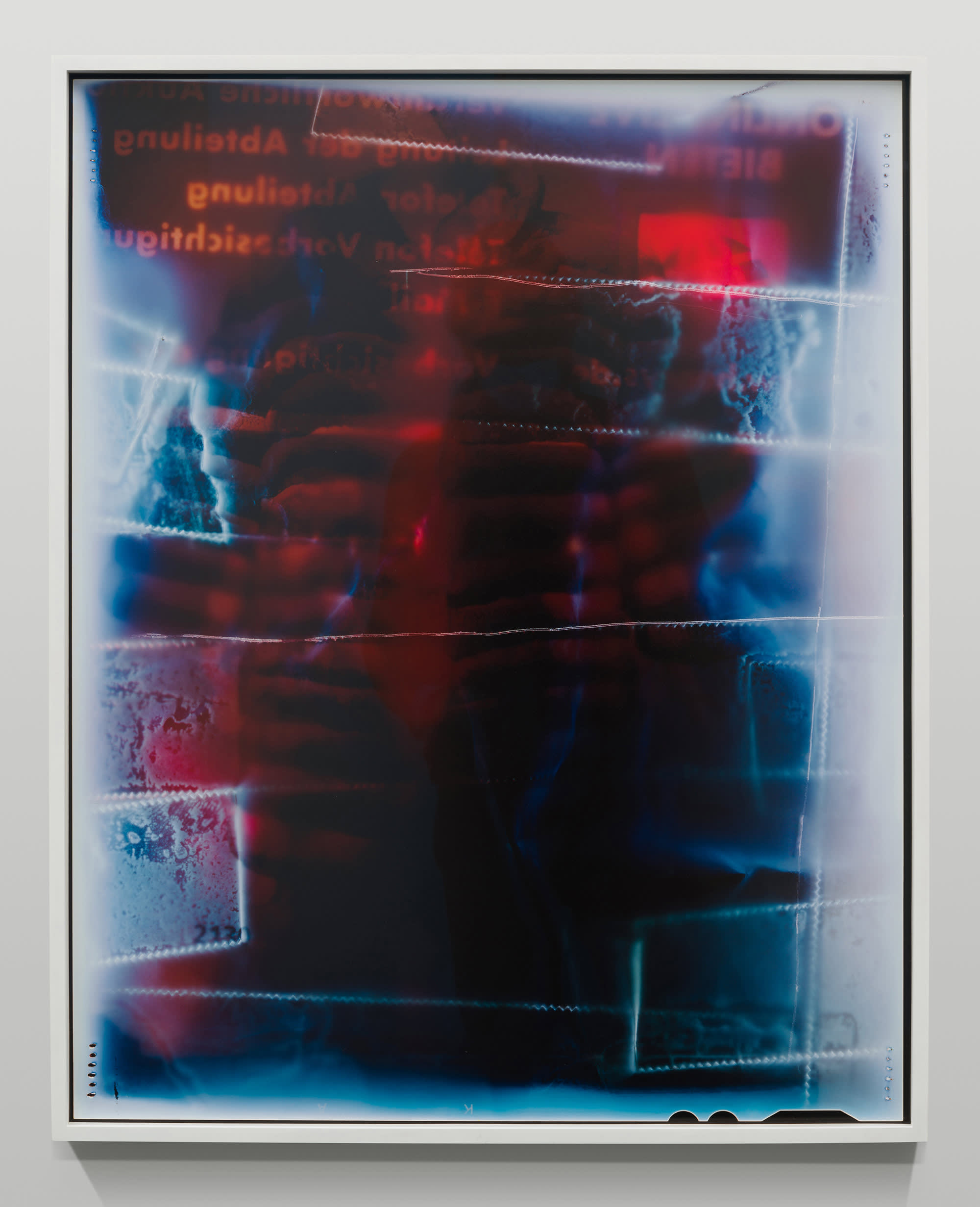 Abstract blue and red photograph with obscured text and scratched lines going horizontally across the image.