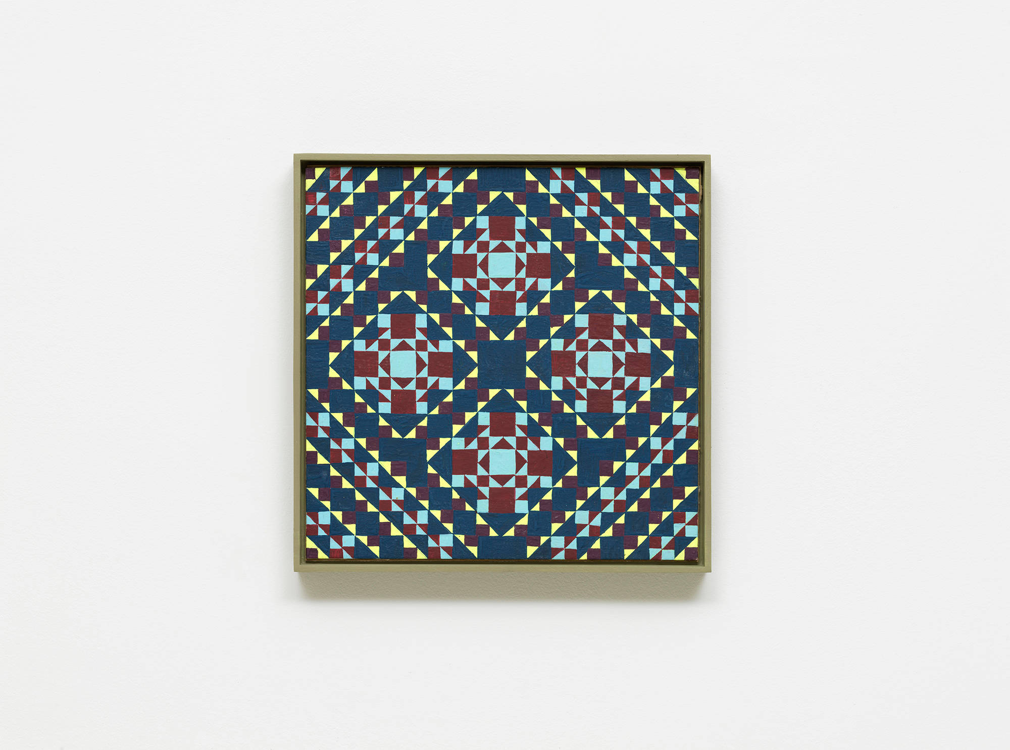 A colorful, intricate grid painting installed on a white wall.