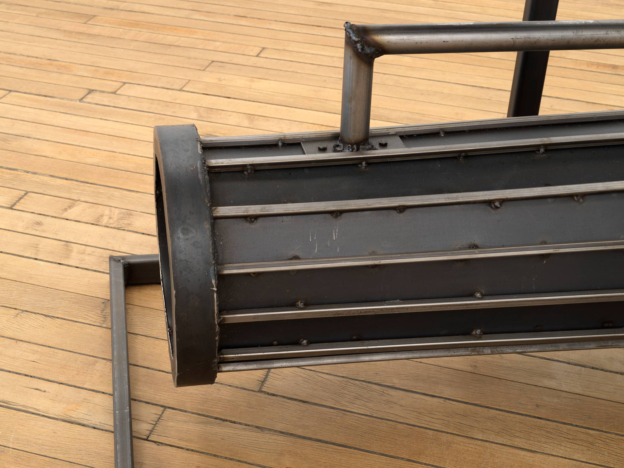 Detail of a steel sculpture resting on top of a wooden flower.
