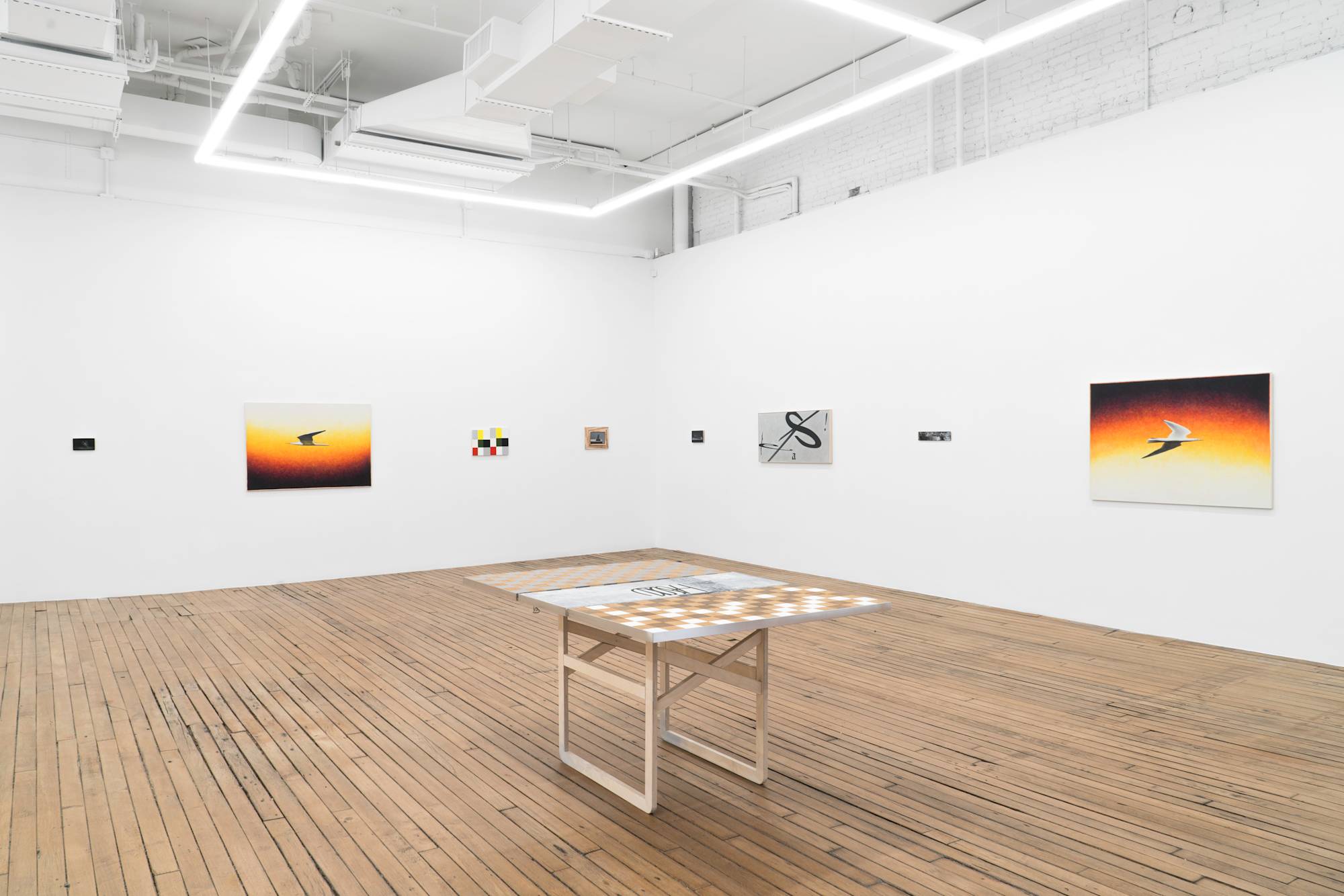 View of gallery with 8 Ian Miyamura paintings hanging on the wall, evenly spaced. A table sculpture sits in the center of the gallery.