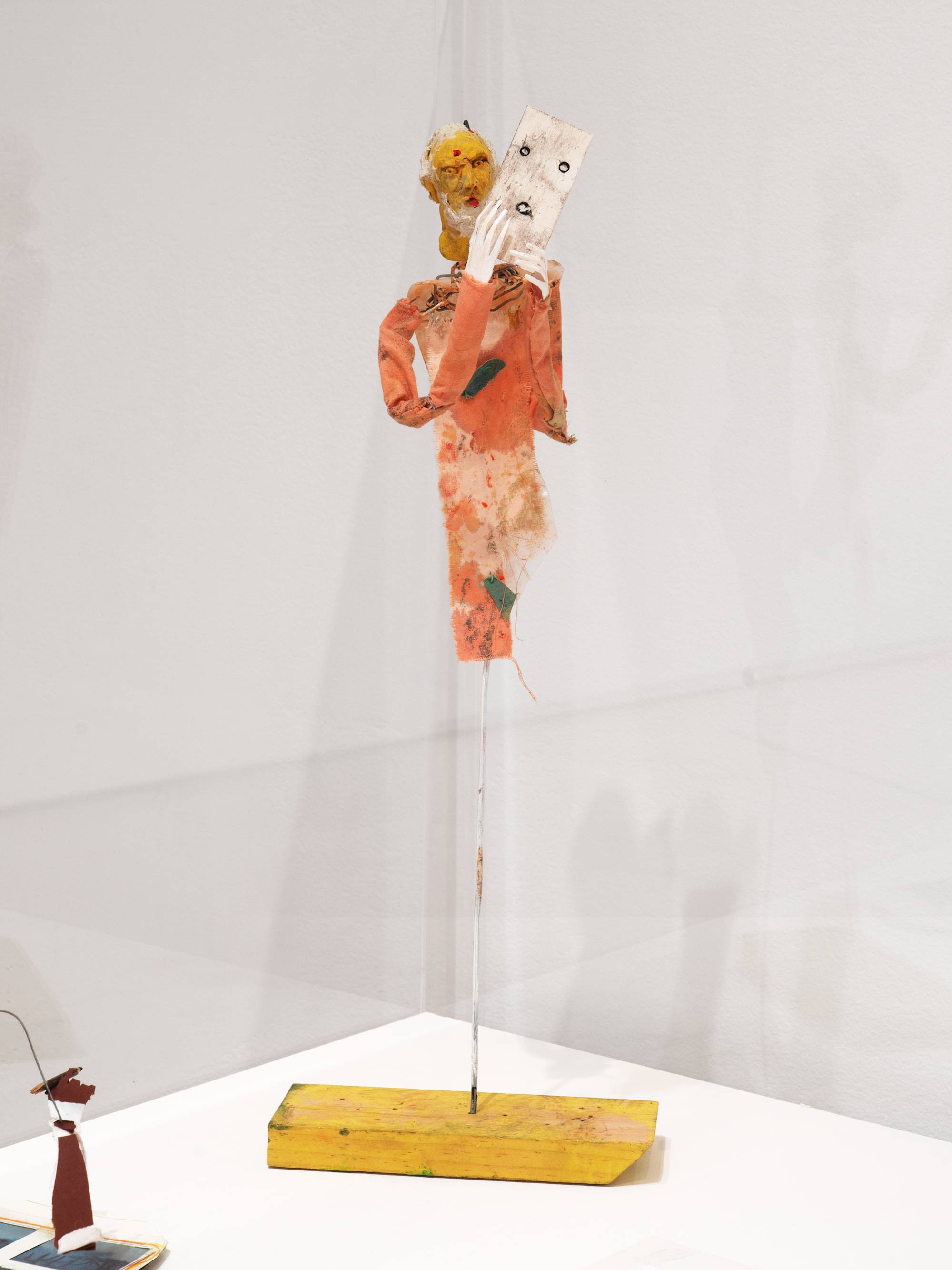 How to Change Faces, 2024, Tempera, ink, ash, acrylic, charcoal, graphite, and tape on papier-mâché, modeling compound, high-density polyethylene, string, wire, cloth, and wood, 18 × 6 ½ × 4 in. (45.72 × 16.51 × 10.16 cm)