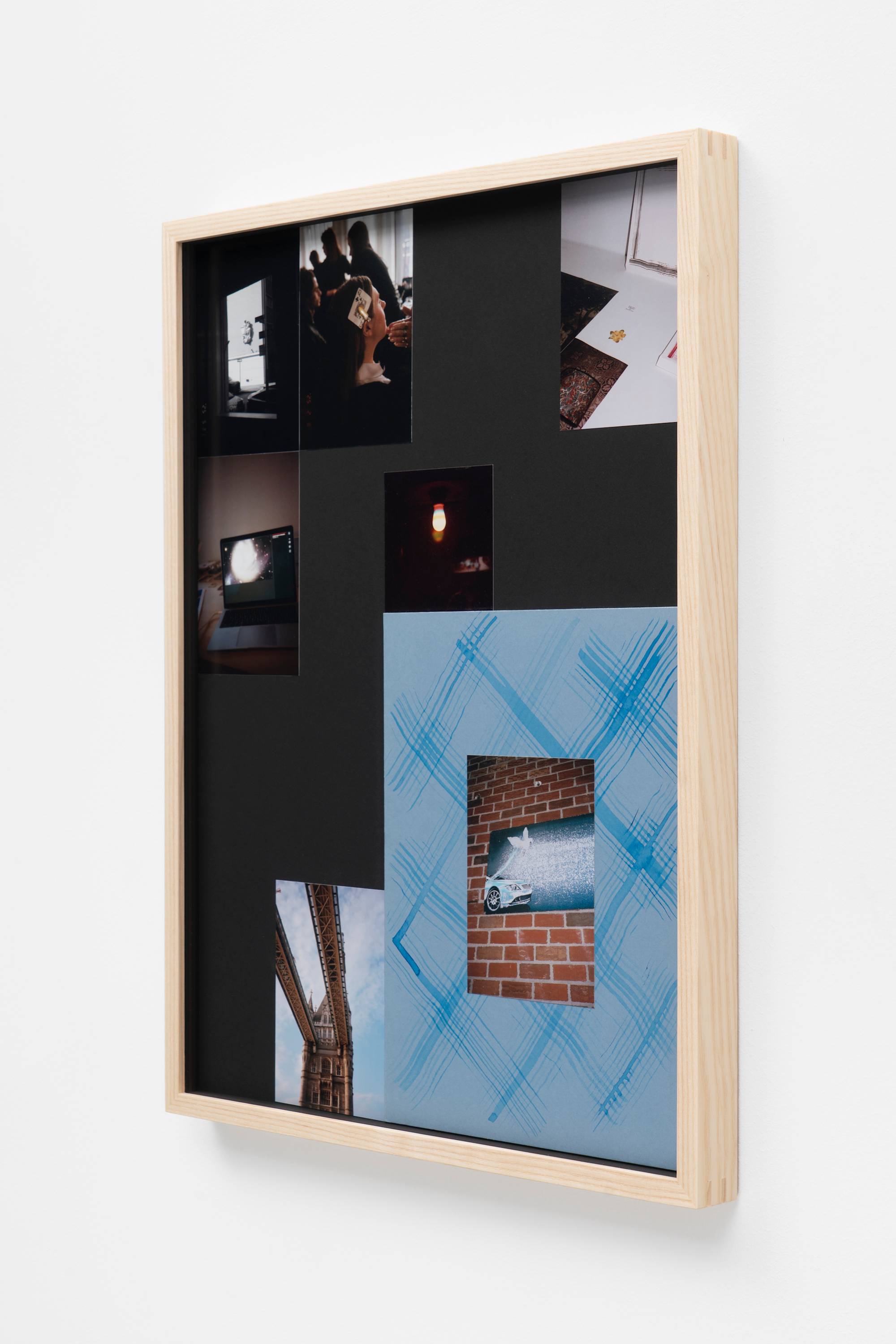 In a wood frame, a series of small photographs and mementos are arranged together, photographed from the side.