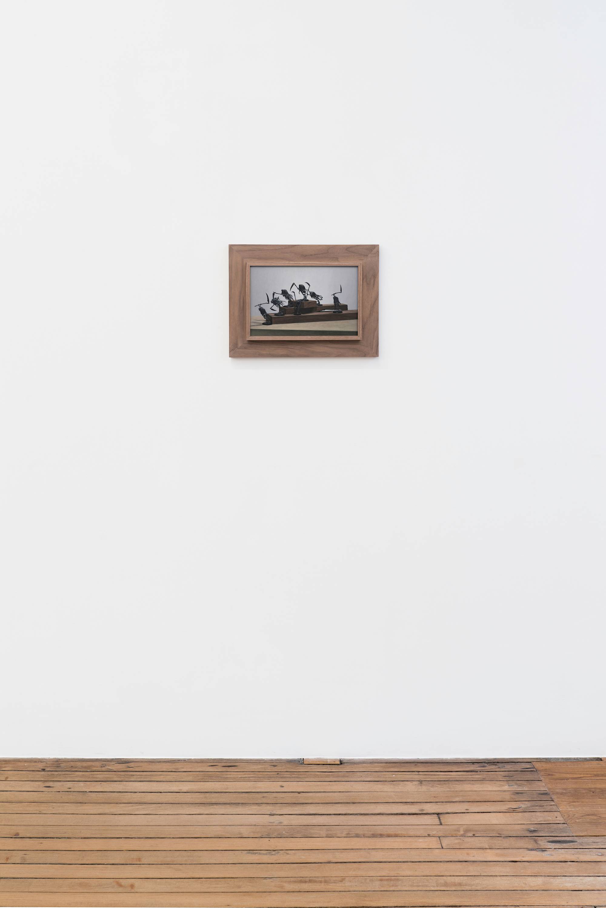 Ian Miyamura painting depicting seven unpainted Warhammer figures against a light grey background arranged on 3 tiers of wood blocks hangs on the wall of a gallery above a wood floor.