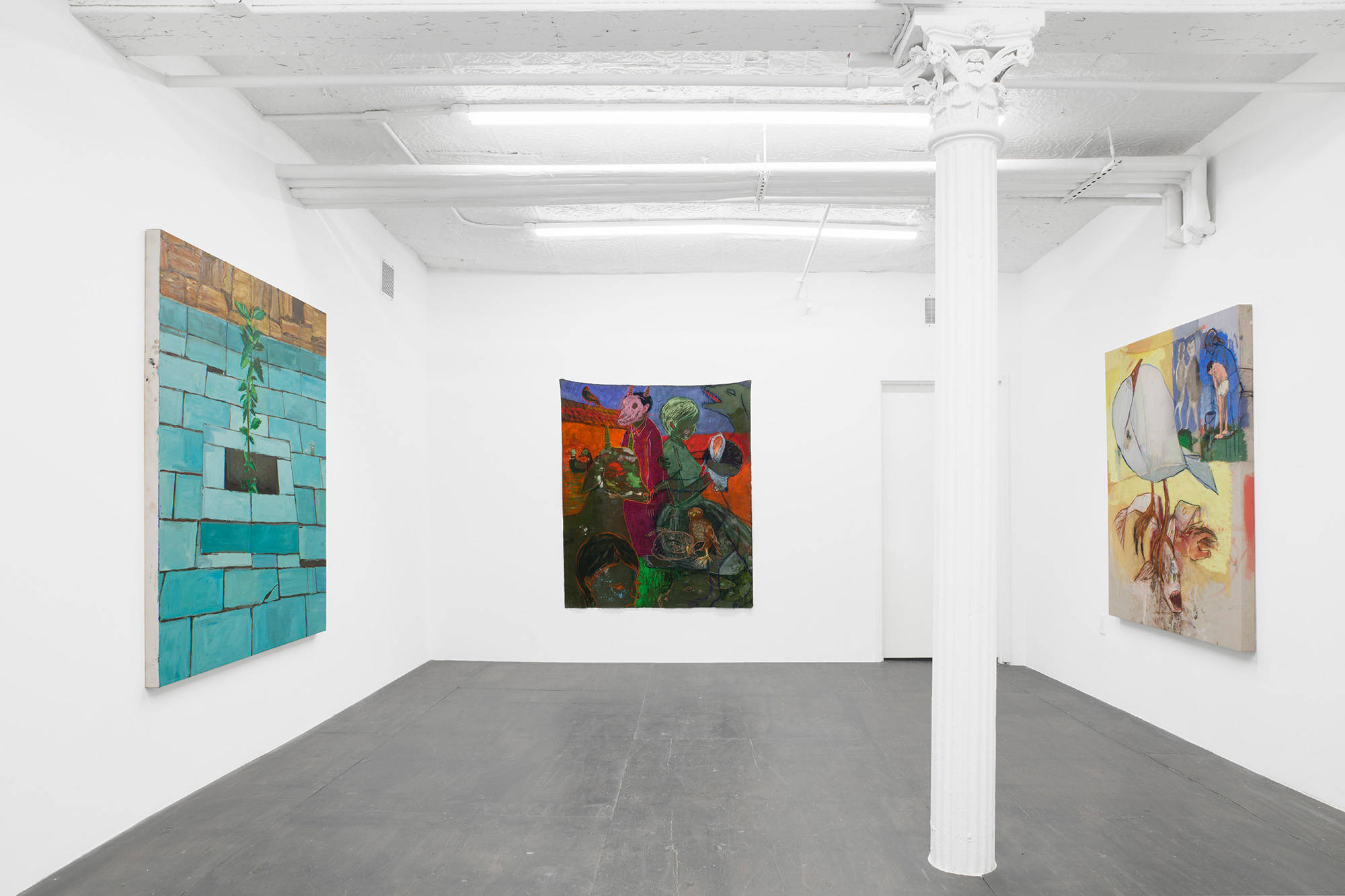 Three paintings hang on three separate walls in the downstairs room of the gallery. A white pillar dissects the room one third from the right edge. The paintings consist of a plant, abstracted figures, and a seagull.