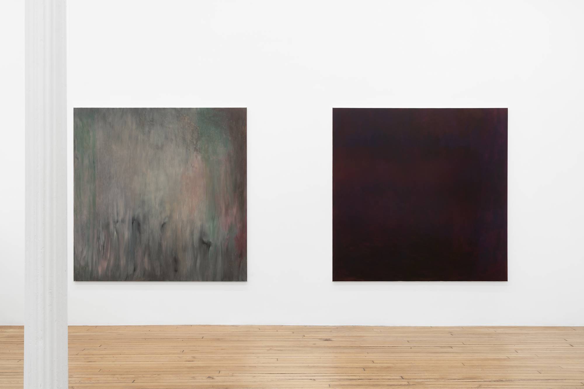 Two large square abstract paintings installed close to each other on a long gallery wall.