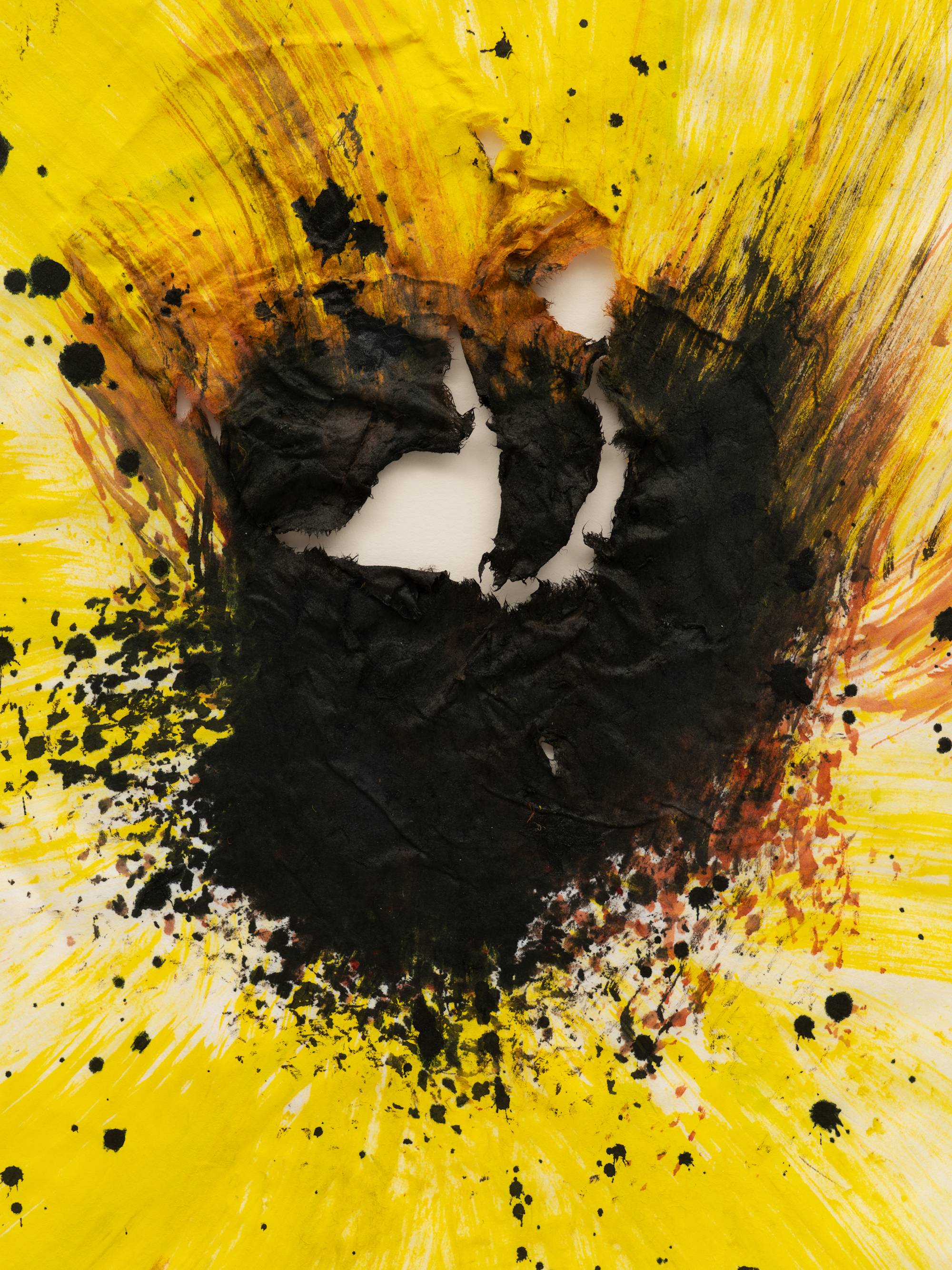 A close-up shot of an ink painting on paper, depicting a sunflower: its petals are a cool yellow, and rendered in sweeping, gestural brushstokes, and the center of the flower is executed in splattered black ink. The paper is torn at the black center of the flower, which is emphasized by the close-up shot. The shot is cropped so that frame is not visible.
