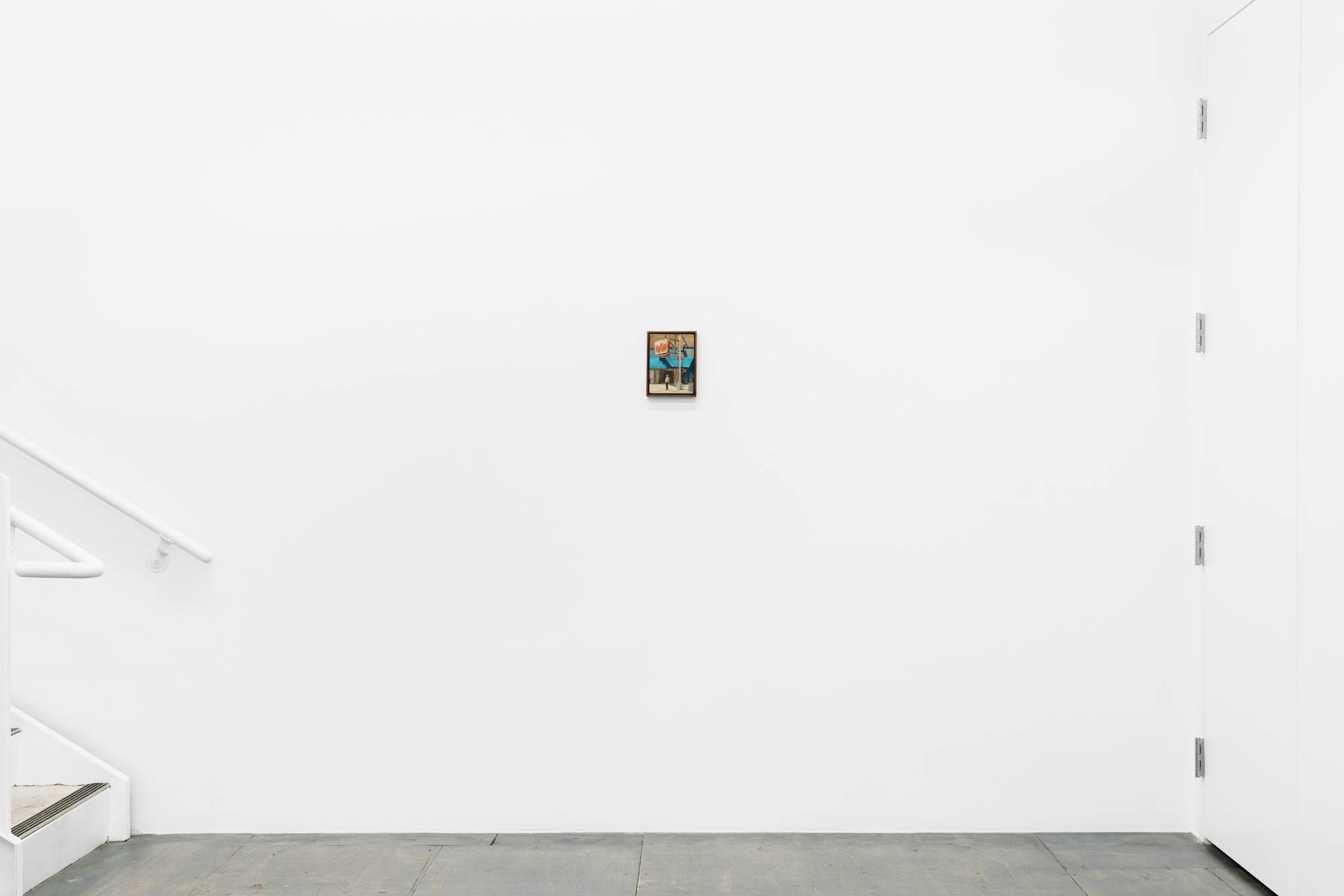 Installation view of a small, dark wood framed painting of a figure standing beneath a car wash sign on a street corner.