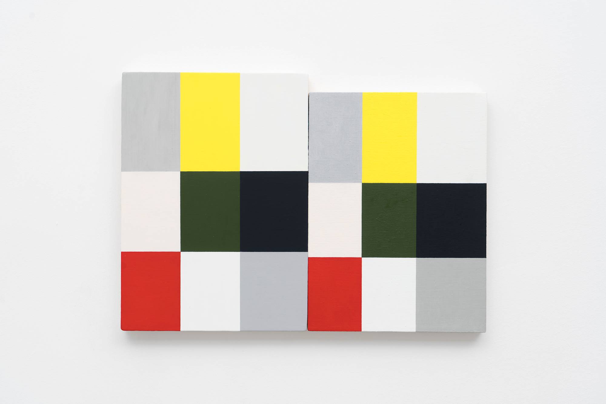 Two Ian Miyamura paintings of red, green, black, white, yellow, grey, and pink squares hang on the wall butting against each other.