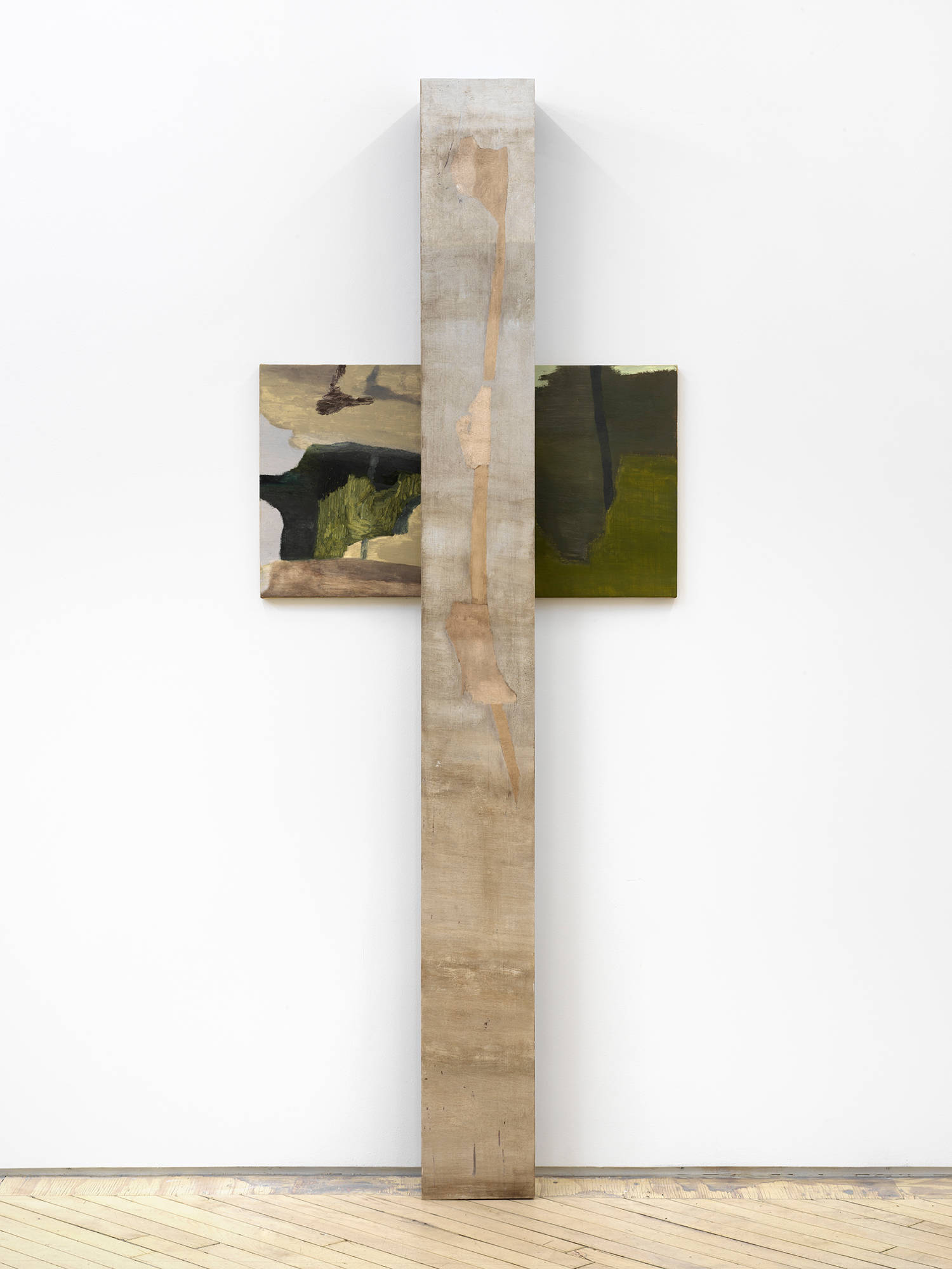 A vertical painting and sculpture resembling a cross installed against a gallery wall.