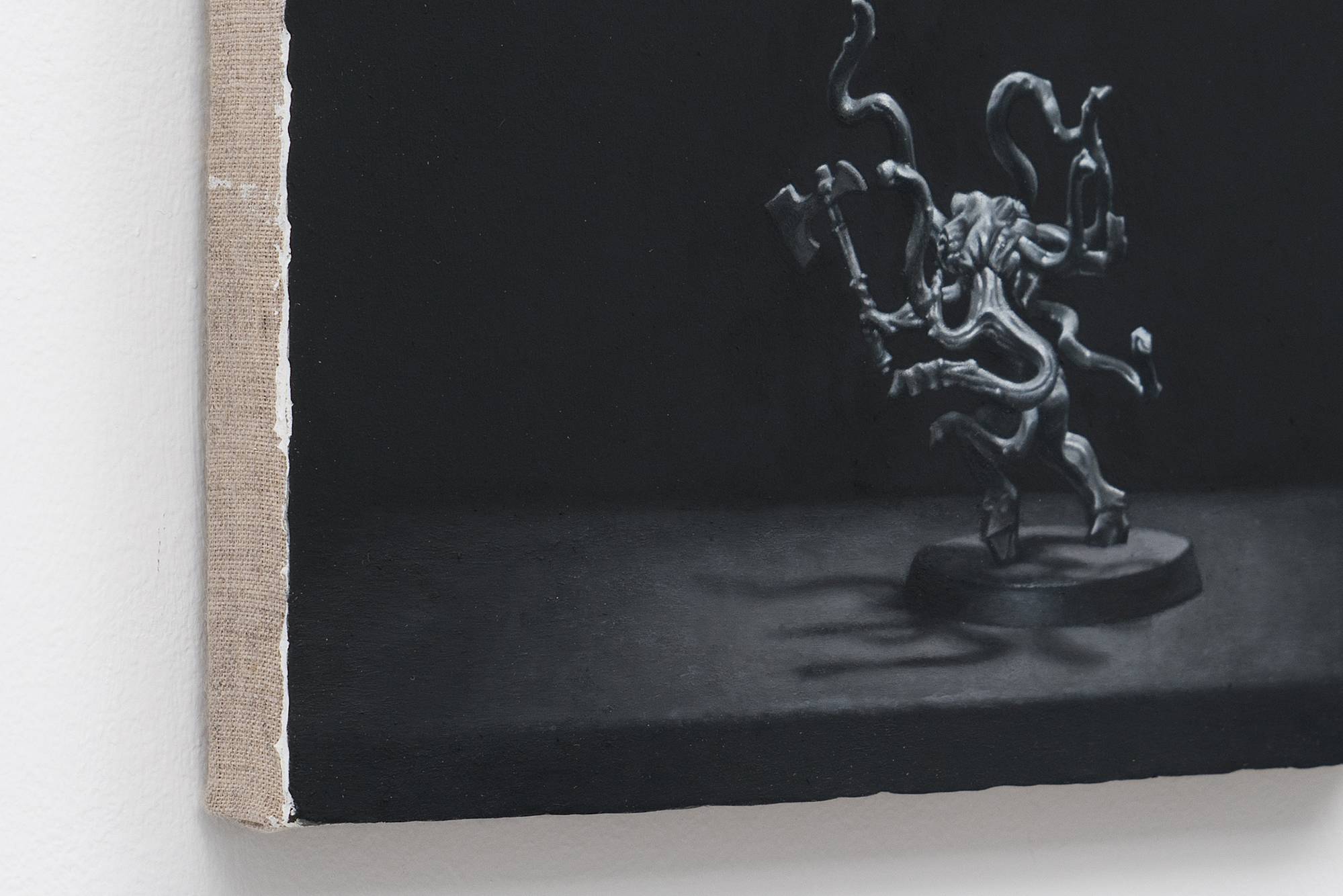 3/4 view of Ian Miyamura painting depicting an unpainted Warhammer figure against a black background.