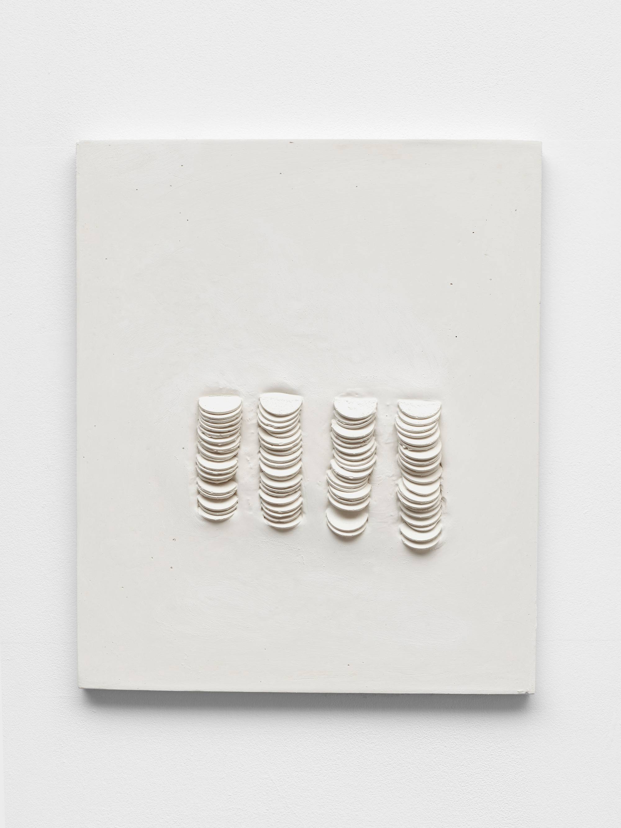 A wall mounted white plaster sculpture featuring 80 cast dollar coins.