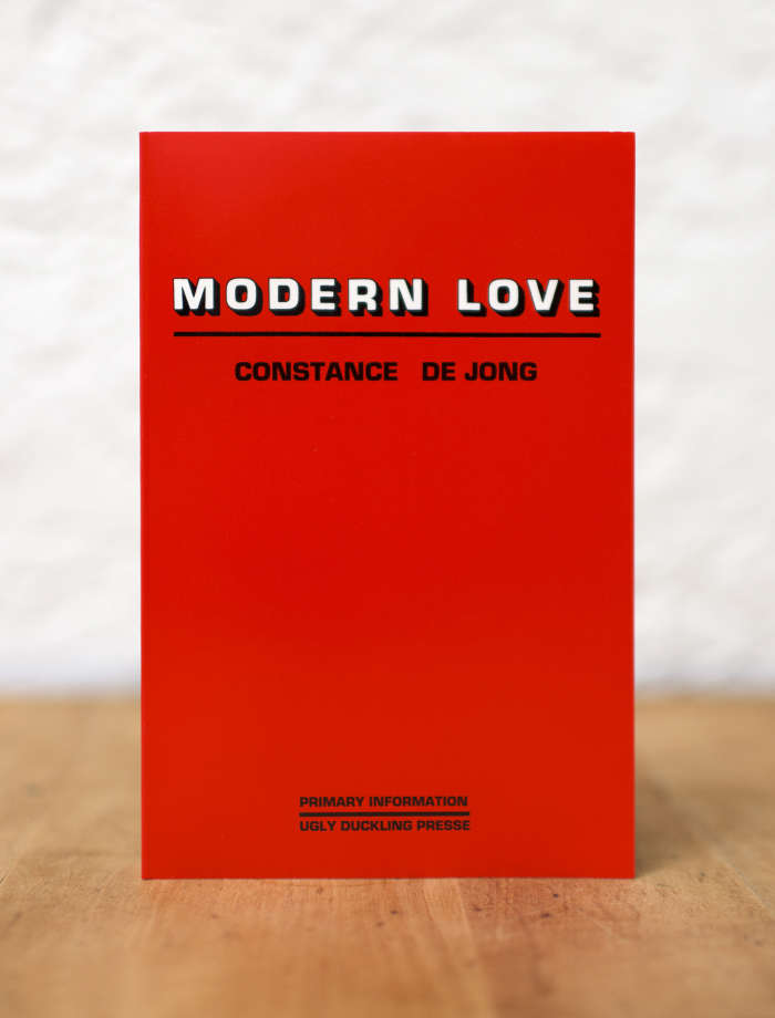 Book by Constance De Jong with a red cover and the words in block lettering "Modern Love" above her name.
