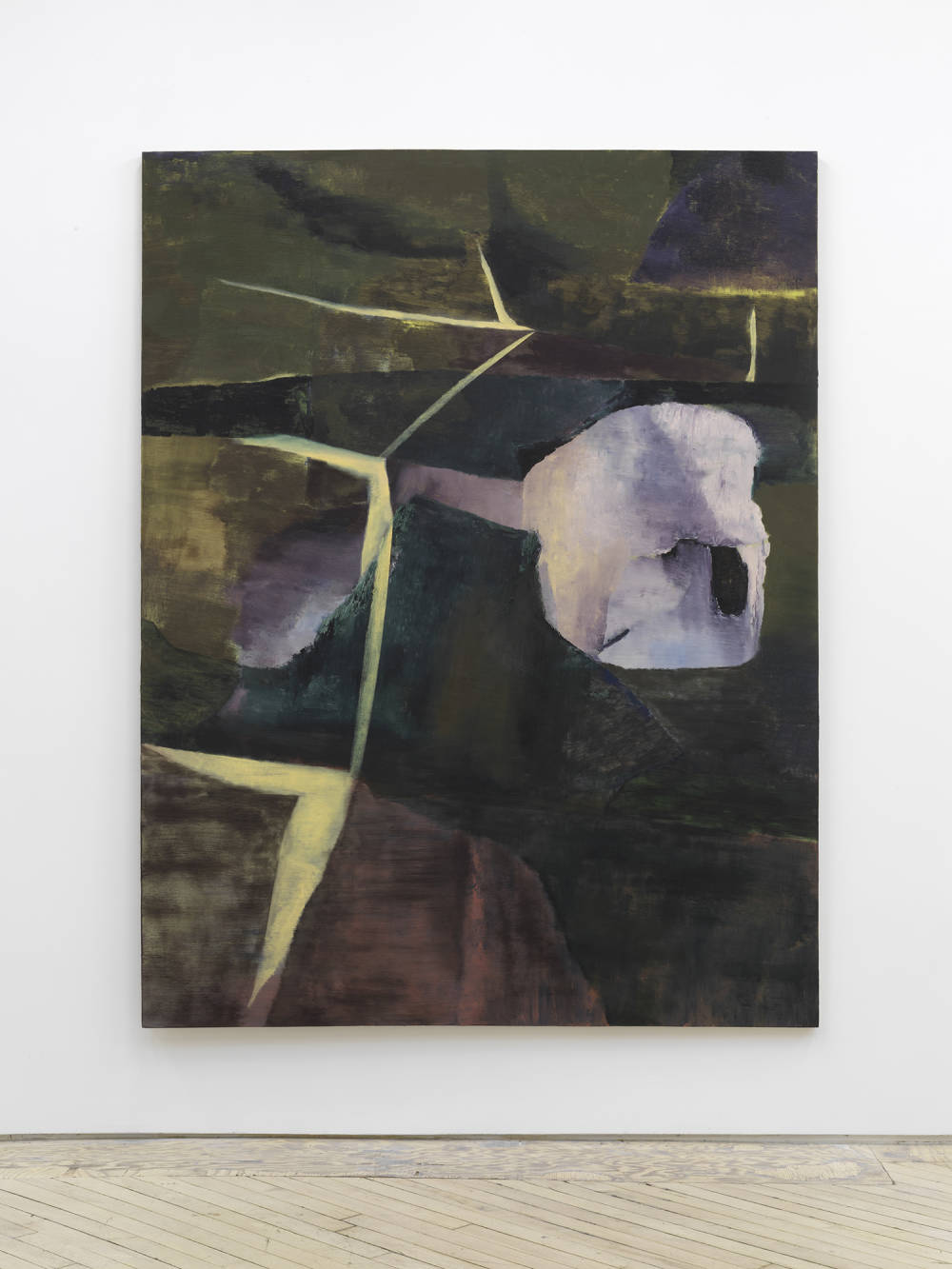 A large, gestural abstract painting rendered a range of muted earth tones installed on a gallery wall.