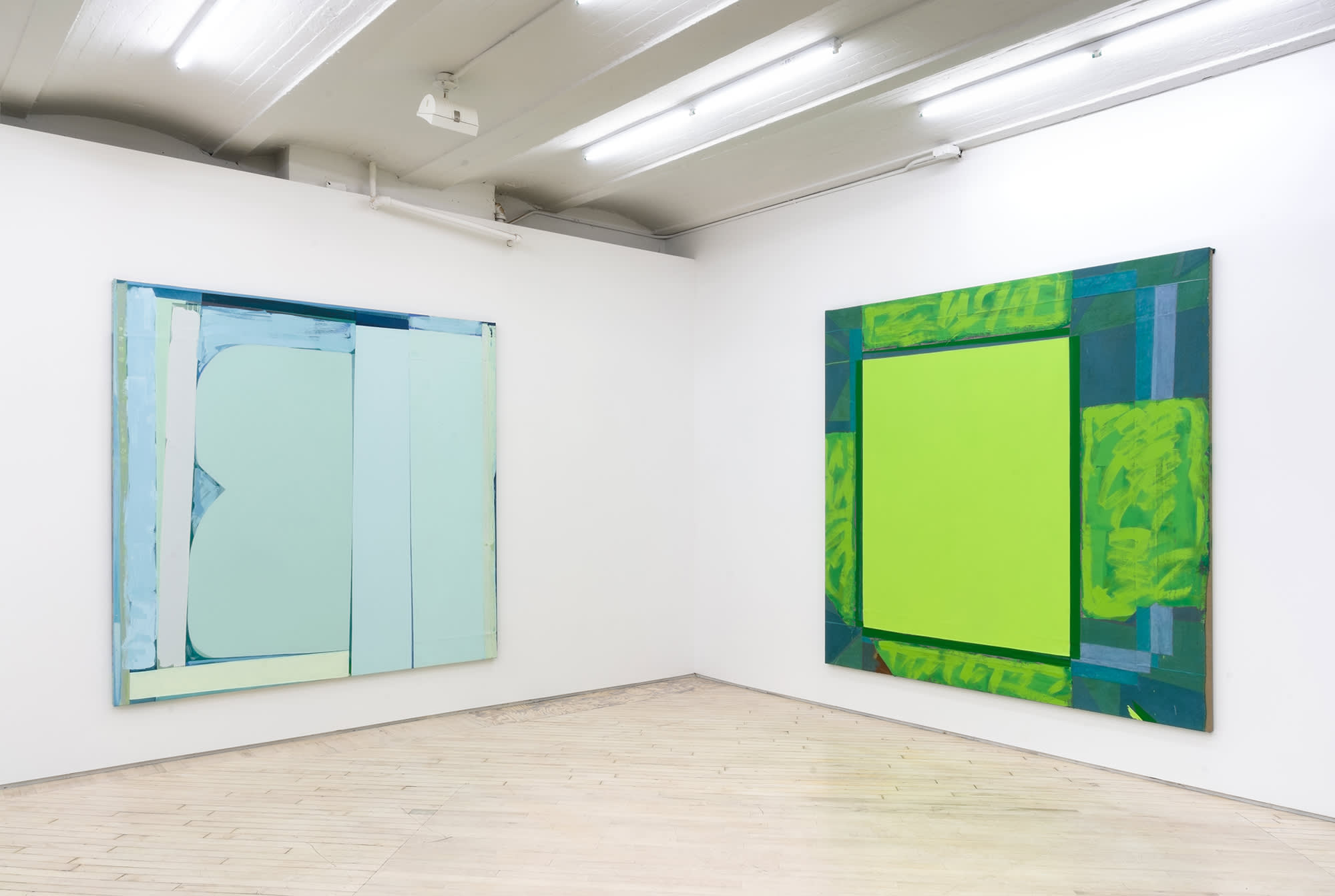 Installation view, corner shot, showing two large abstract paintings, to the left light blue and to the right bright highlighter yellow with darker green edges.