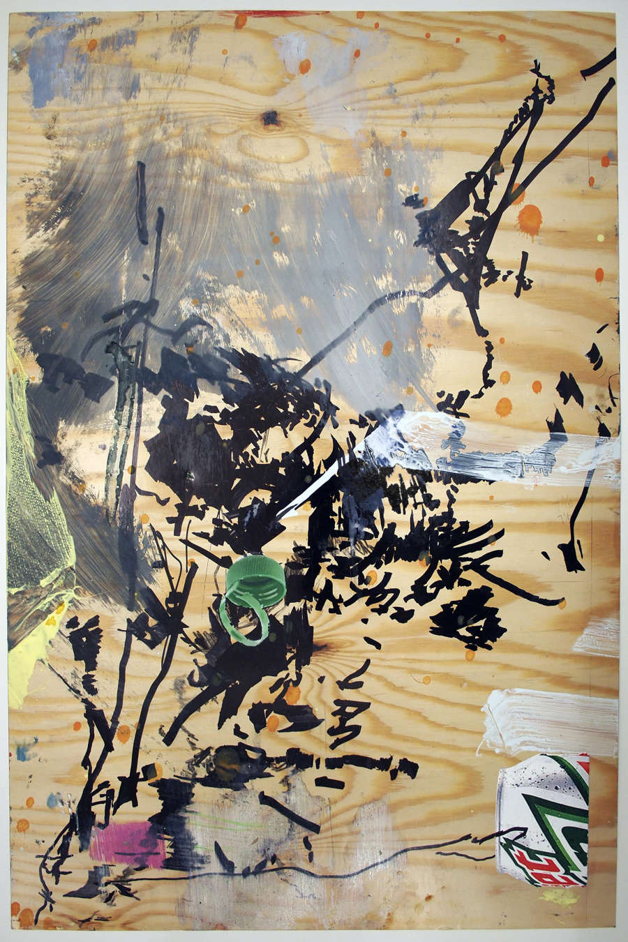 An abstract drawing depicting a series of gestural marks made by a brush. The majority of the marks are rendered in black. There is a partial cut-out of a Mountain Dew can and a bottle cap. The background resembles natural wood.