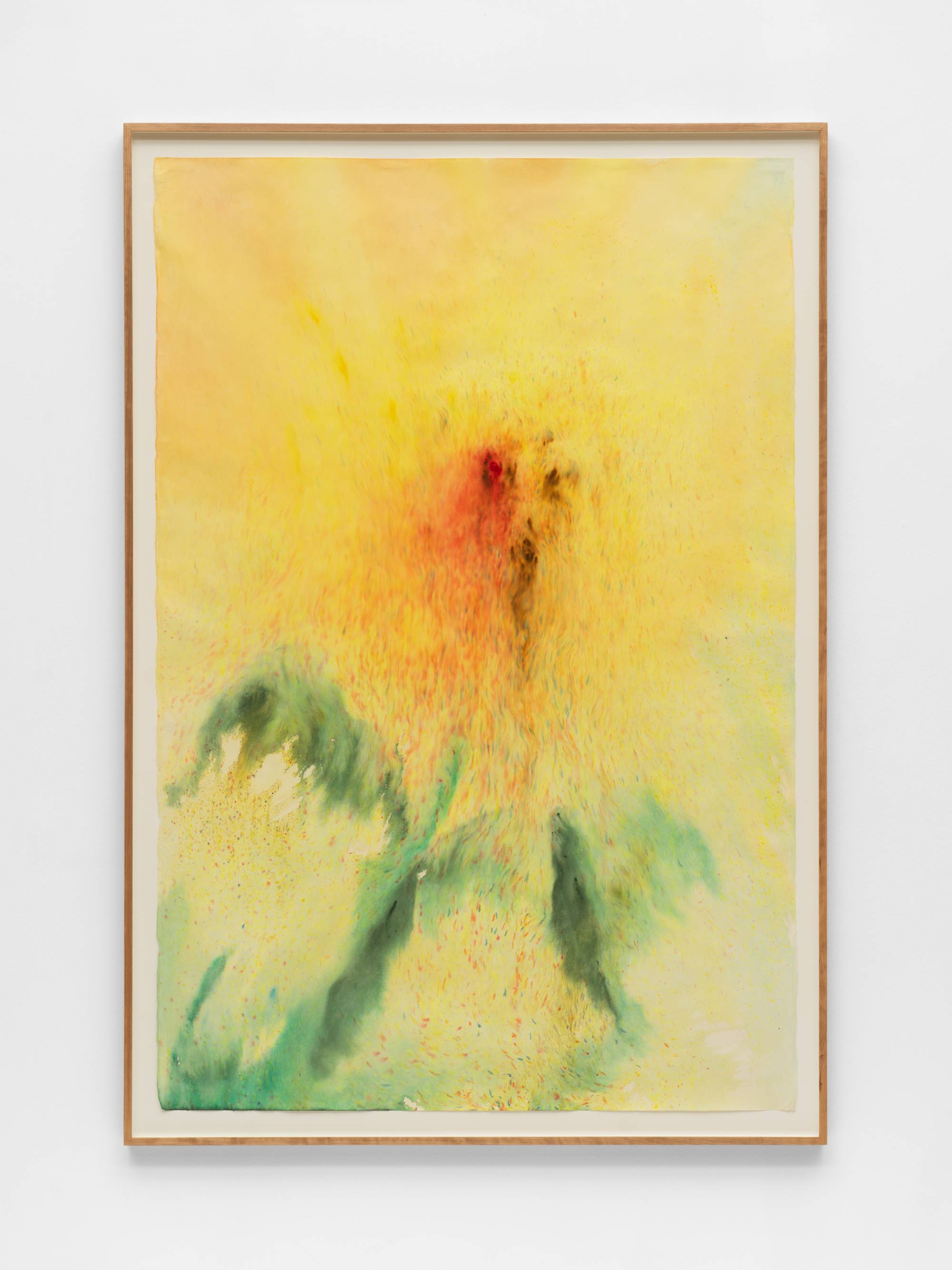 An ink painting of a yellow sunflower with cool green leaves and stem. The sunflower is rendered in blurry and imprecise brushwork; its petals diffuse into the yellow of the background. The center of the sunflower has concentrations of red and brown color; dots of these same colors emanate from the center across the composition. The frame and the wall the work is mounted on is visible in the shot.