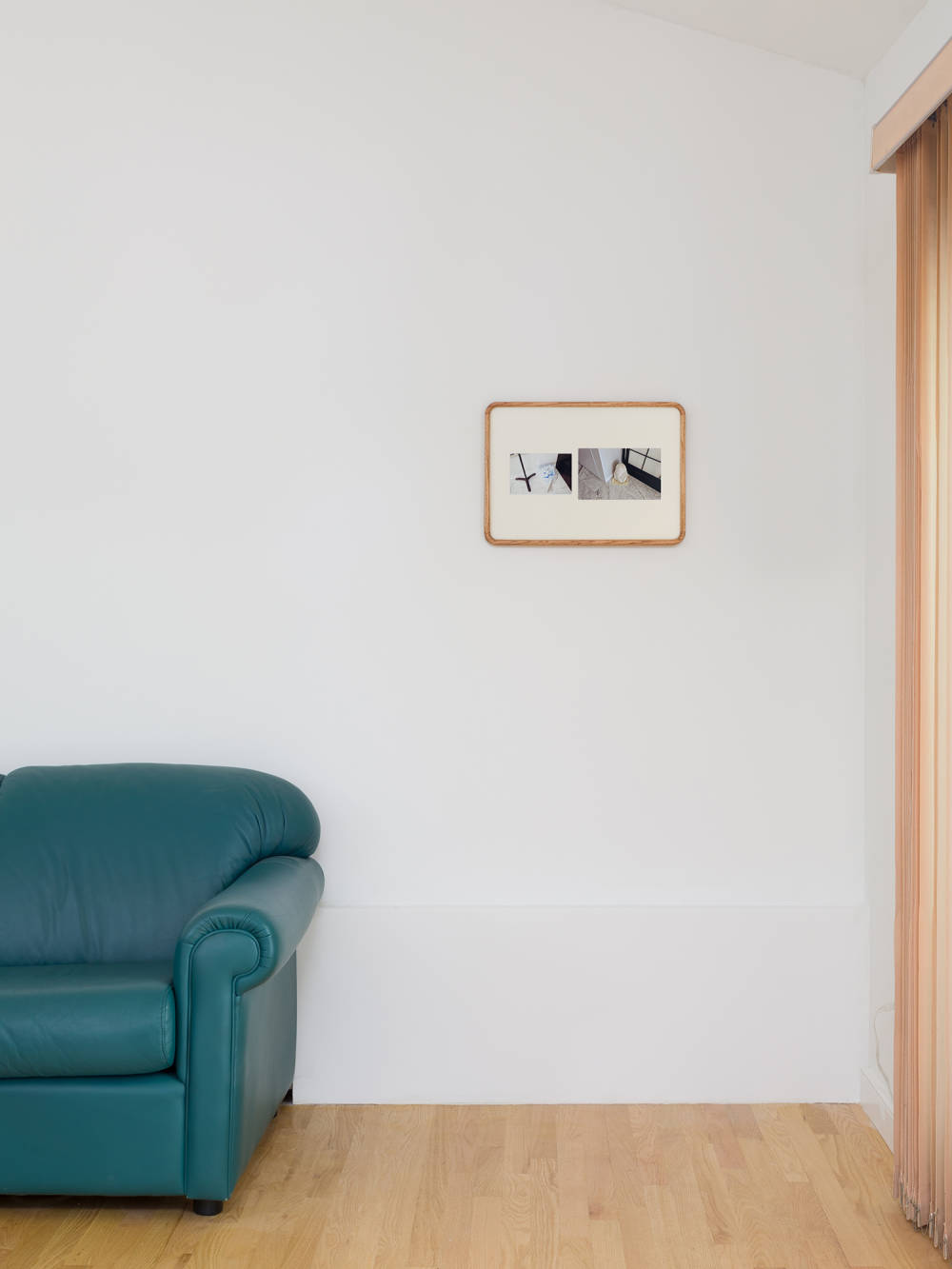 A small wooden frame next to a blue leather couch. 
