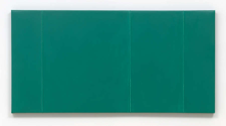 Close-up of a green monochromatic painting with four vertical ridges. 