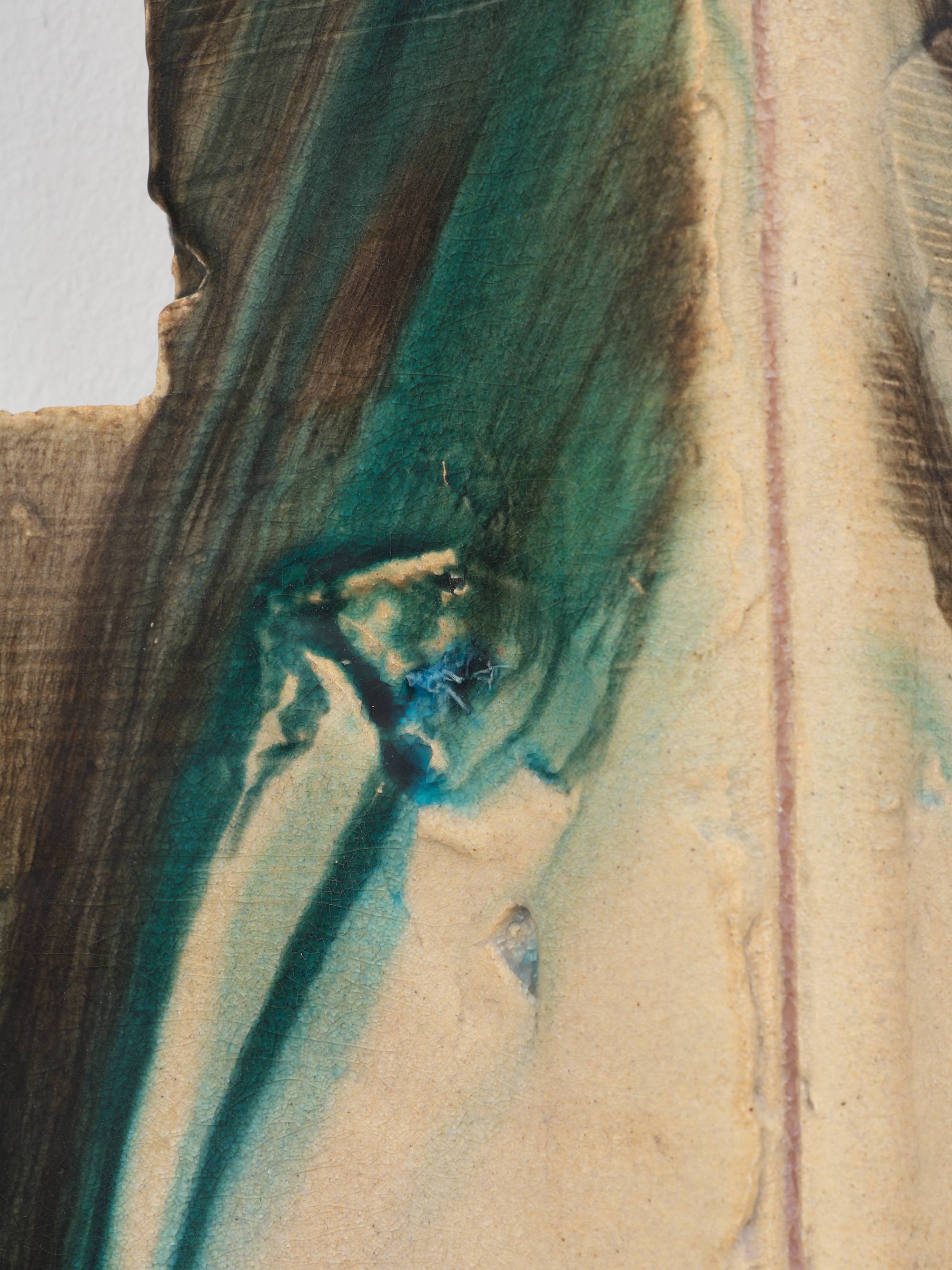 Detail of four individual cross shaped ceramic sculptures mounted to a white wall in a square orientation to form the shape of a pound sign (#). They are glazed in hues of aqua, red, and yellow.