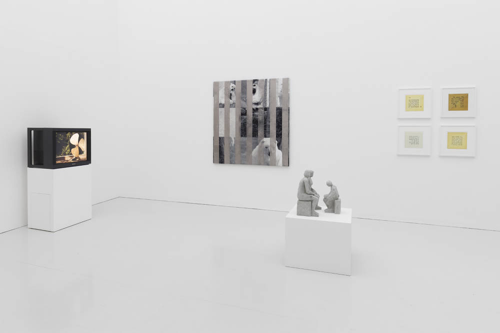 Installation view of Condo London exhibition taking place at Kate MacGarry gallery with several artworks in a white room with gray floors. 