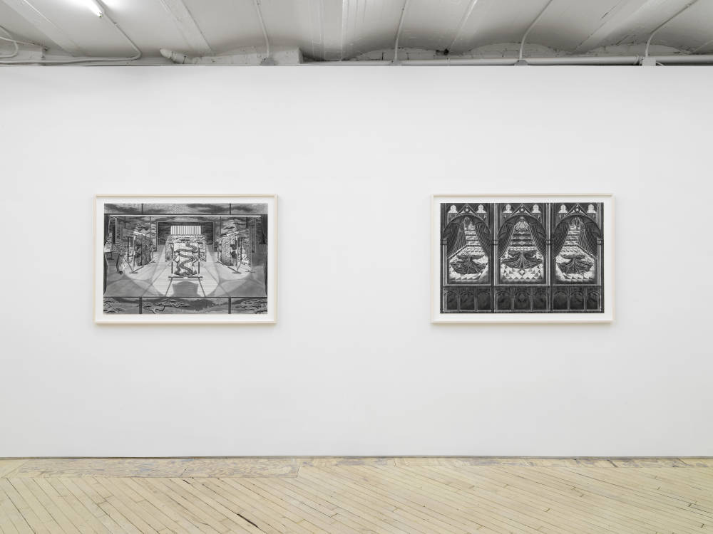 Two large ink and graphite drawings depicting intricate interior spaces hanging evenly spaced apart in off-white frames.