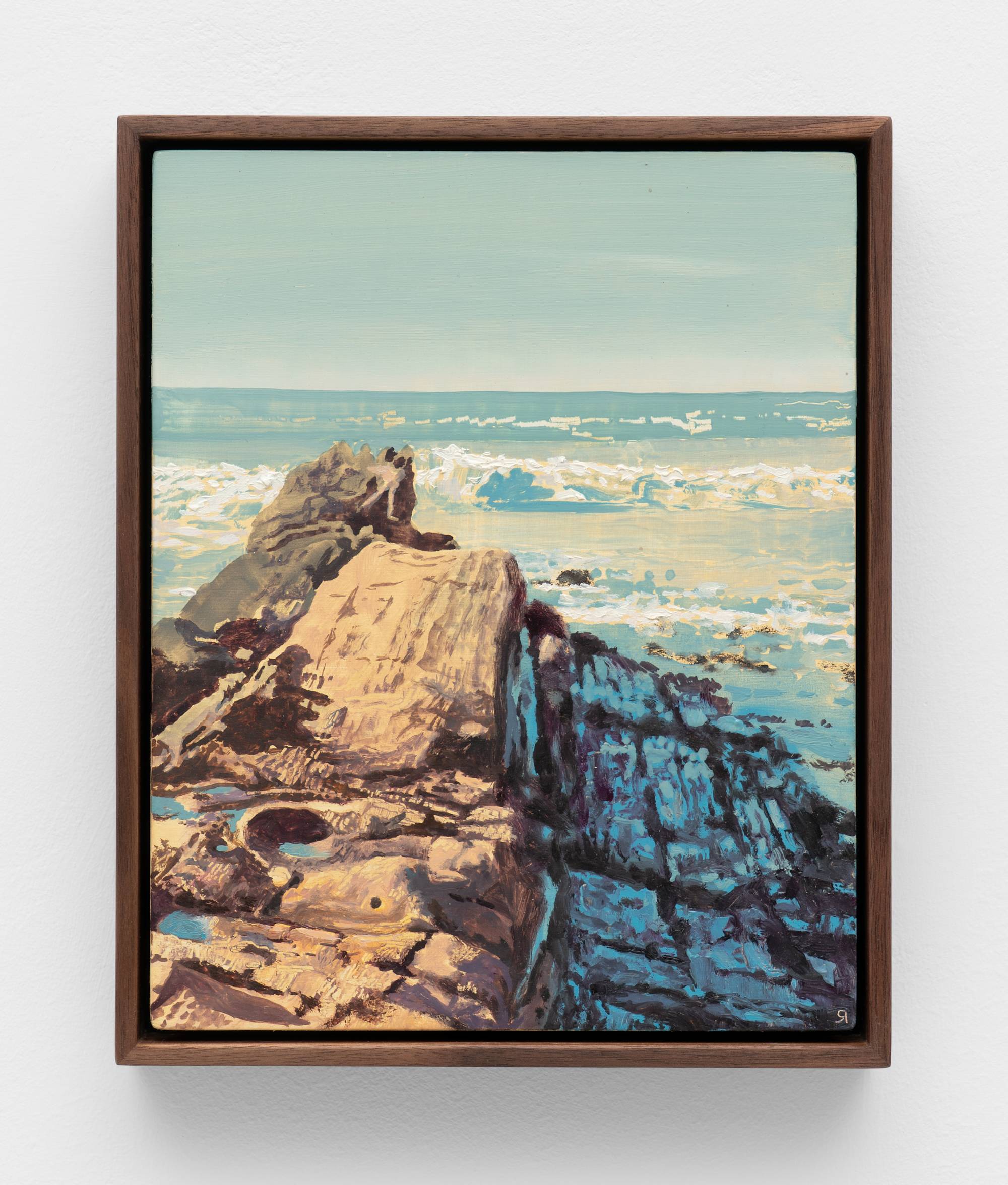 A small, dark wood framed painting of a rock formation jutting out into the sea.