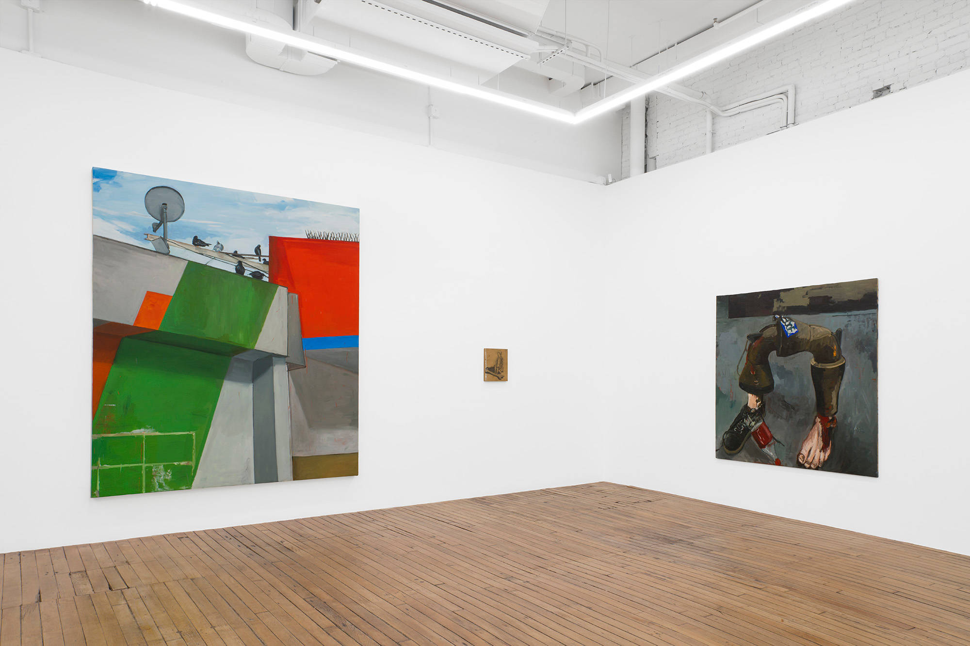 A closer view of the South West corner in the upstairs room of the gallery. This image tightens in on the painting of pigeons, the small drawing on wood, and the pipe with feet.