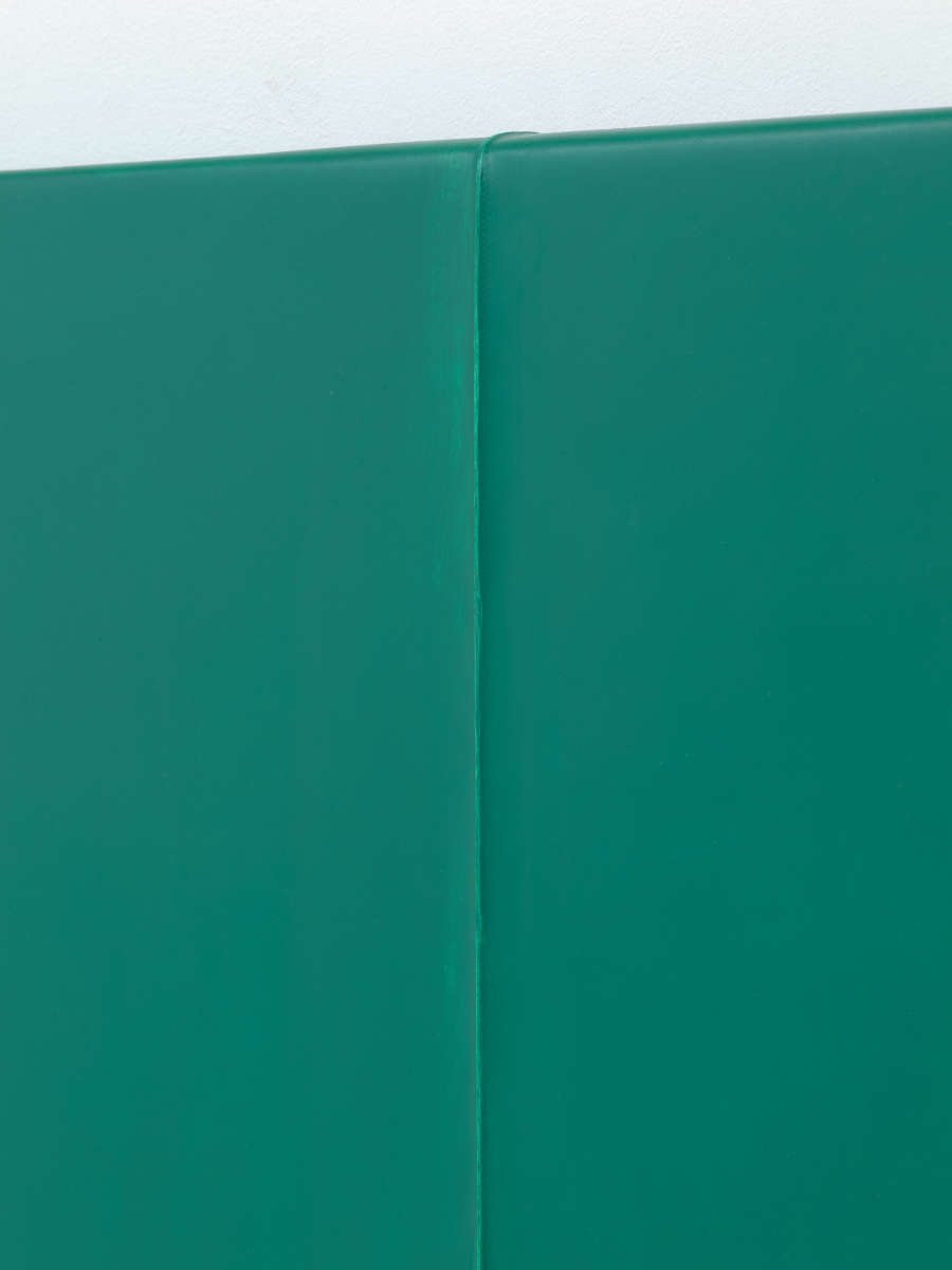 A close-up angle of a crease in a monochromatic green painting.