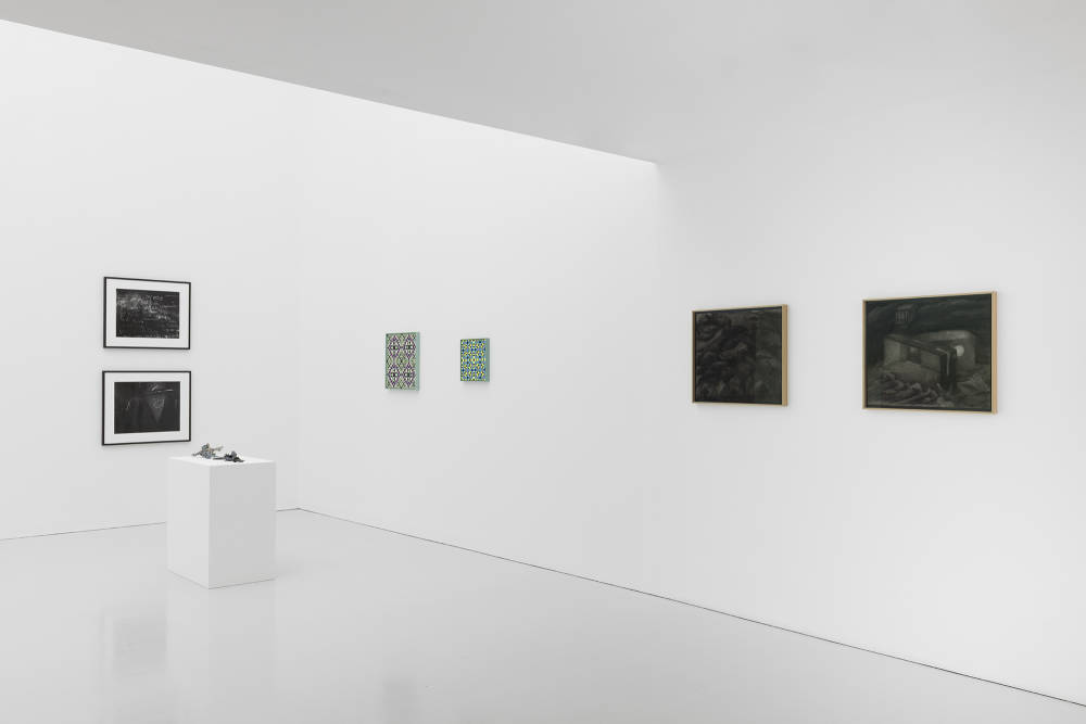 Installation view of Condo London exhibition taking place at Kate MacGarry gallery with several artworks in a white room with gray floors. 
