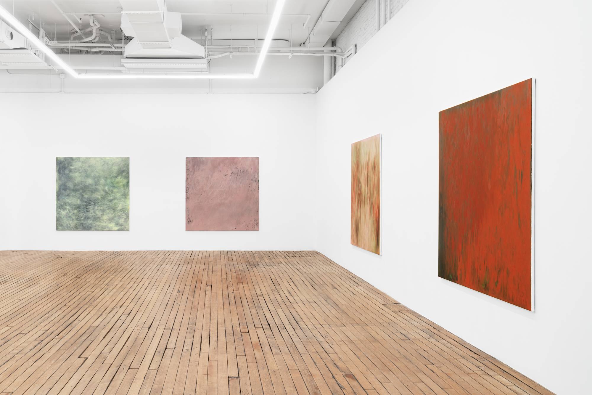 Four large abstract paintings full of gestural marks spaced evenly throughout a brightly lit gallery space.
