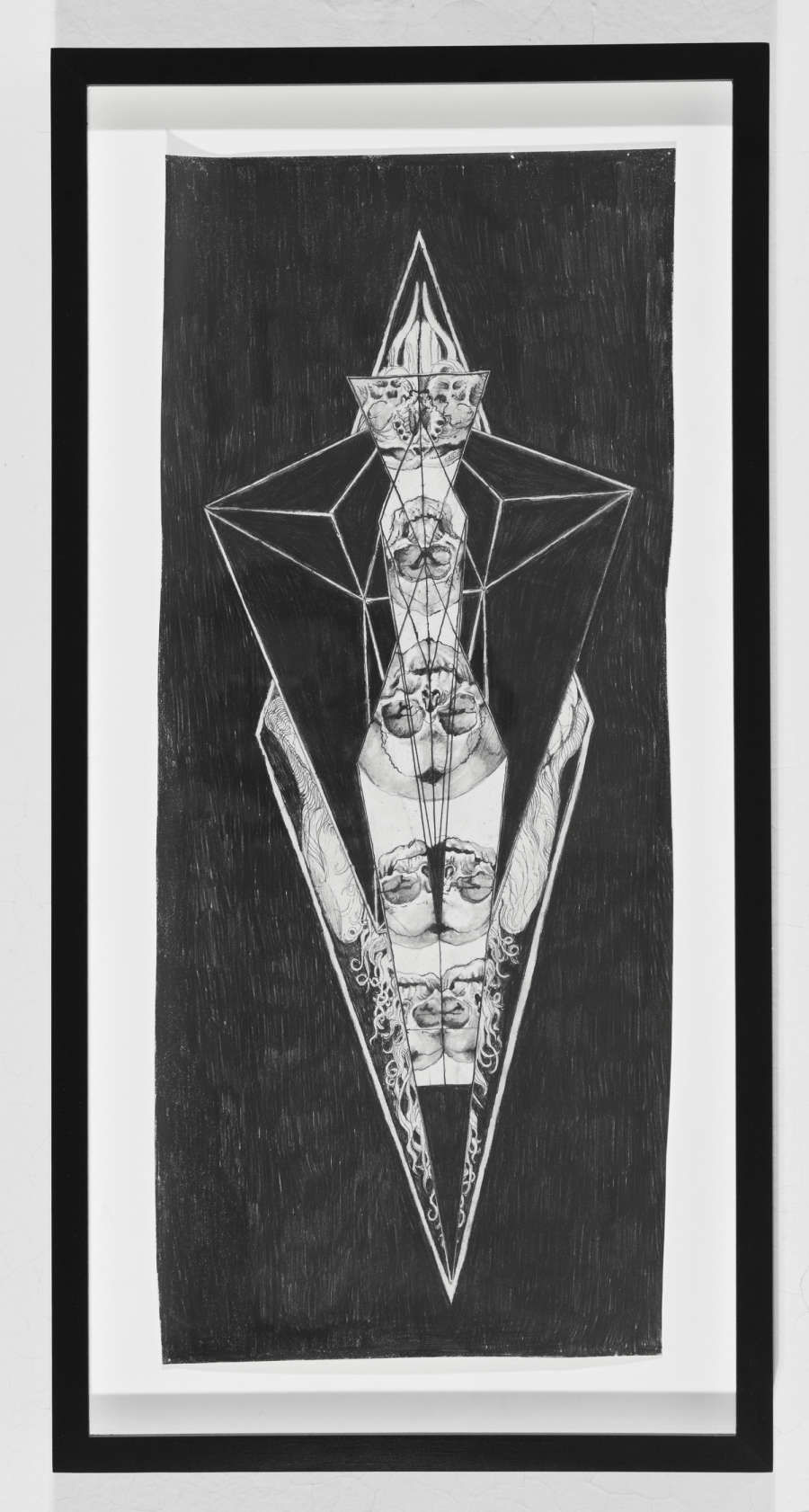 Graphite drawing, mostly black, of diamond shaped geometric lines and skulls doubled and reflected inside of the diamond.