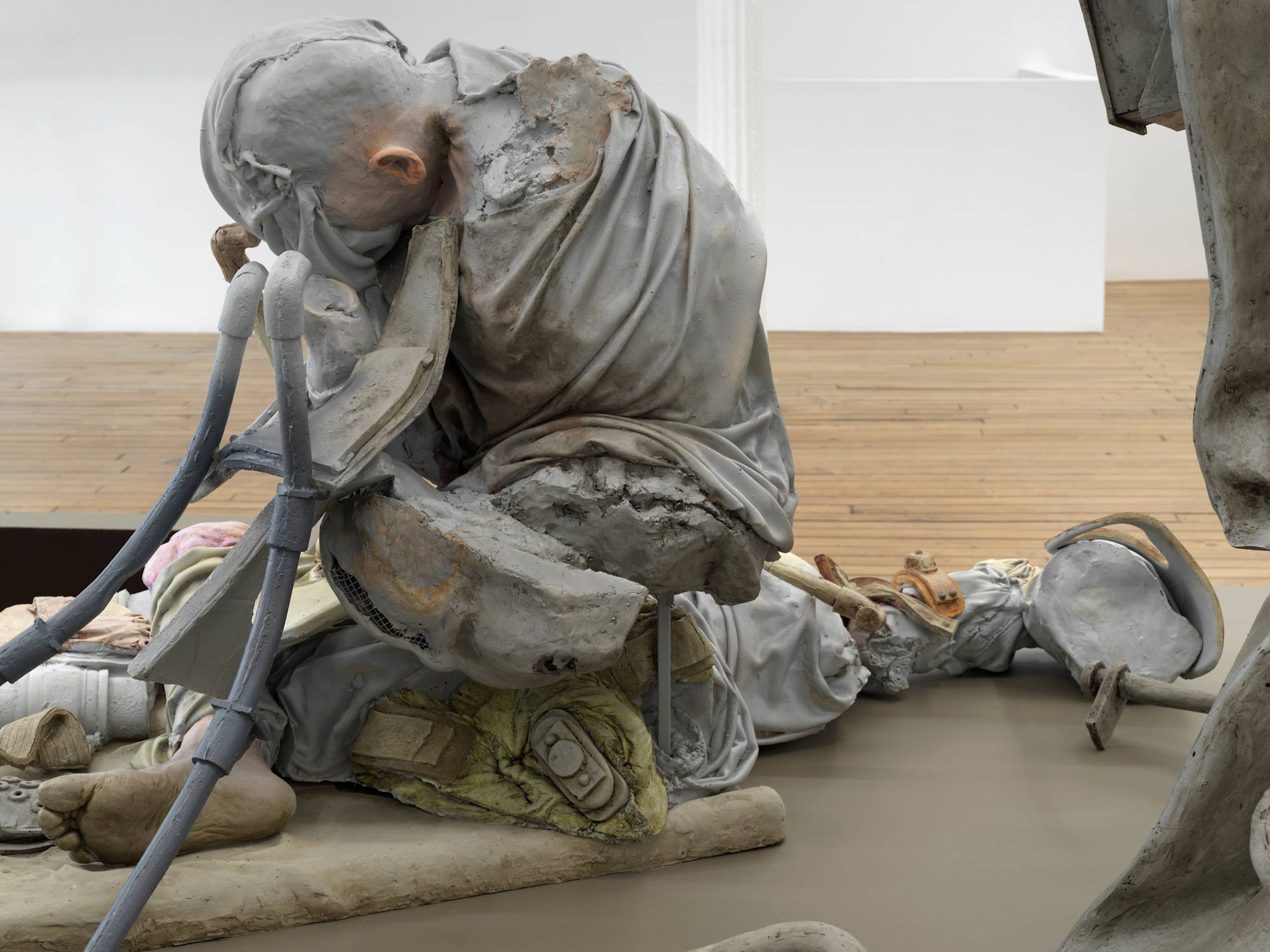 Close up image of a sculpture depicting abstracted human forms and devices.