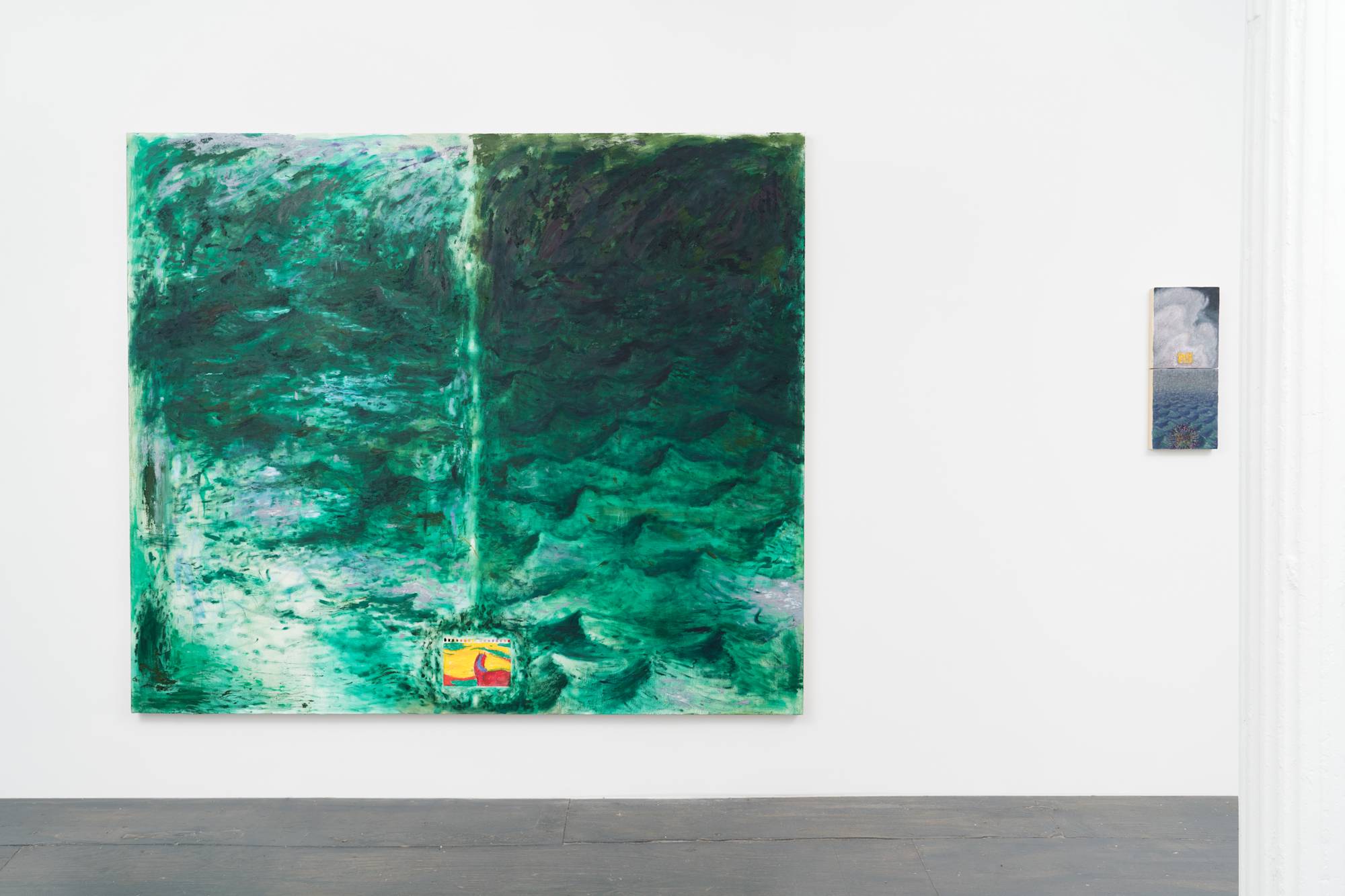 A view of the north wall of the gallery. A large abstract green landscape painting and a small blue vertical landscape diptych hang on the wall. A white column borders the right side of the frame.