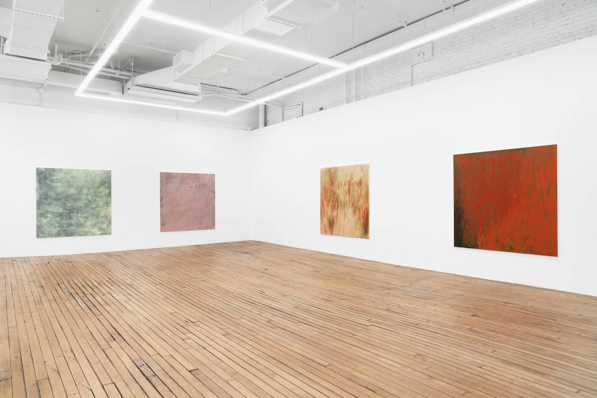 Four large abstract paintings full of gestural marks spaced evenly throughout a brightly lit gallery space.