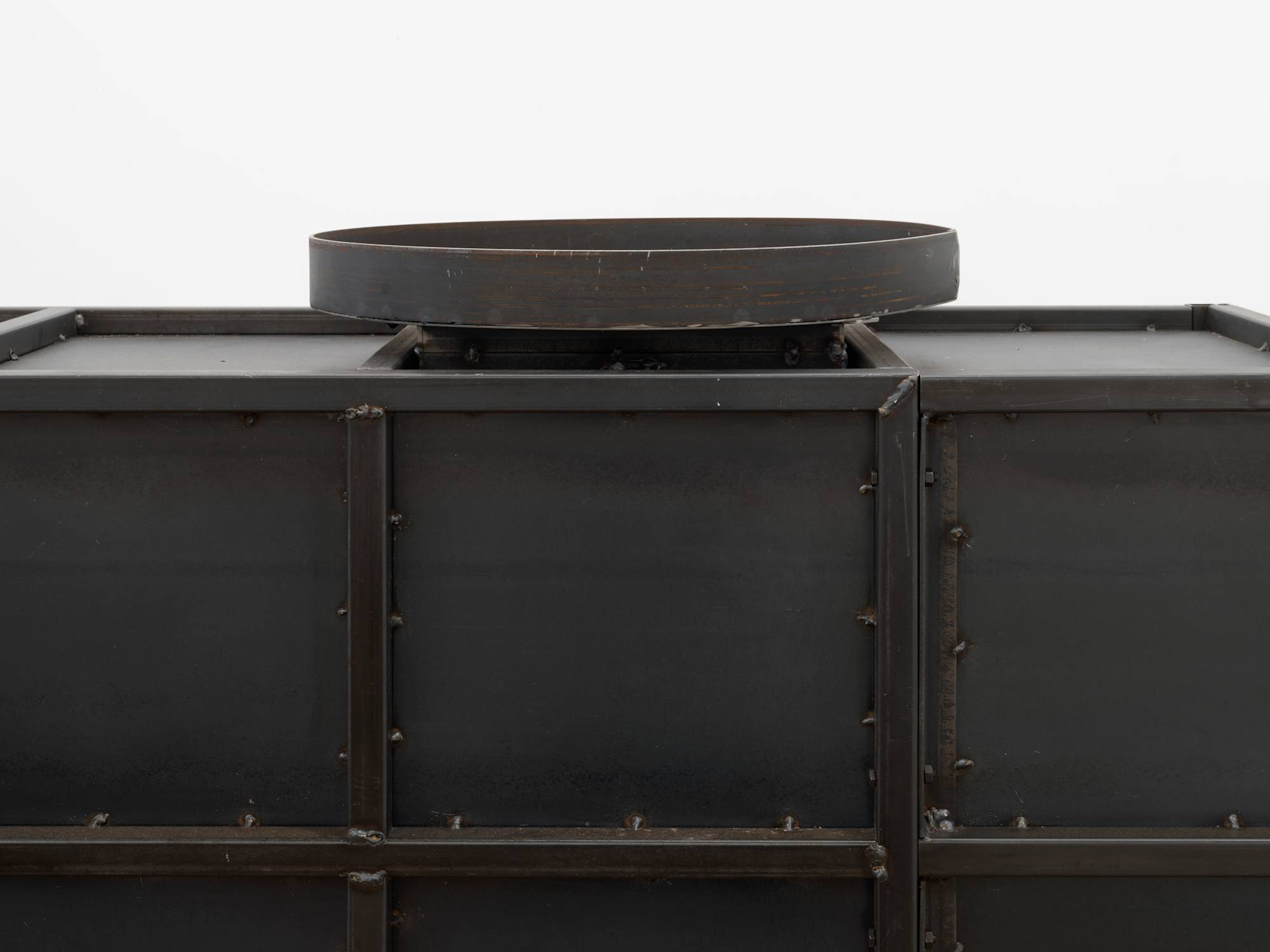 Detail of the top of a large steel sculpture.