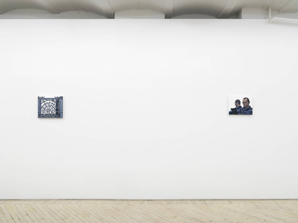 Installation view of two paintings hung distanced on a white wall depicting a milk crate and a police officer figurine.