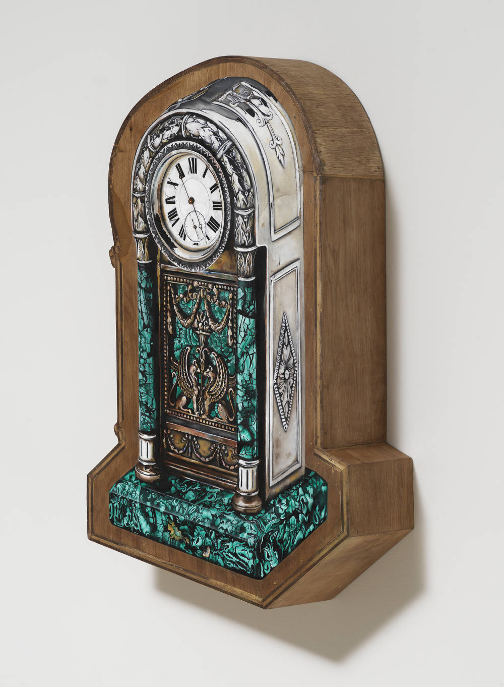 Image of an artwork by Libby Rothfeld of a shaped wooden panel with a very realistically rendered clock painted on the surface. The wood is stained brown and the clock is metallic with green marble.