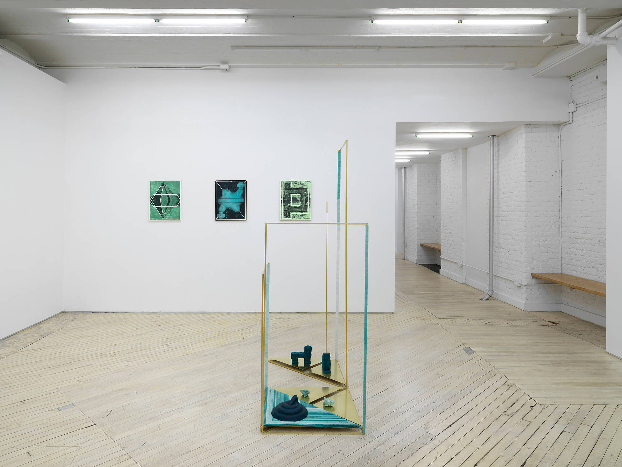Installation view of the exhibition Throughline at Bureau featuring a sculpture in the foreground and three panel paintings by Claudia Peña Salinas on the wall.