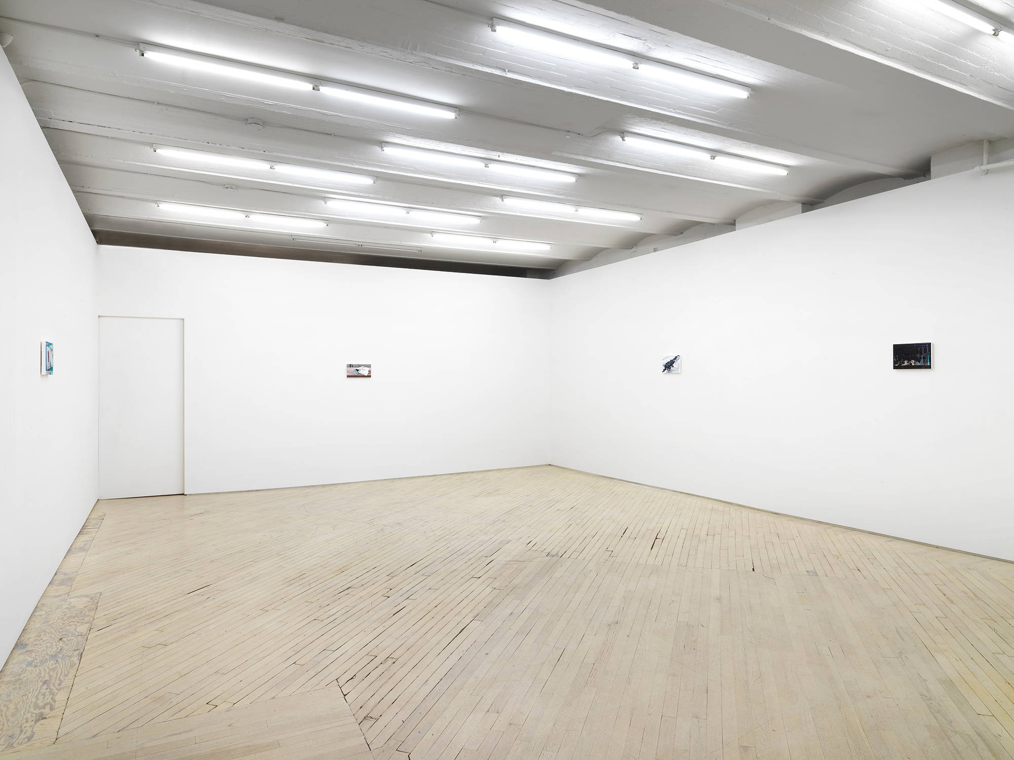 Installation view of an exhibition of paintings by Caleb Considine. Four small paintings hang on the walls of an art gallery.