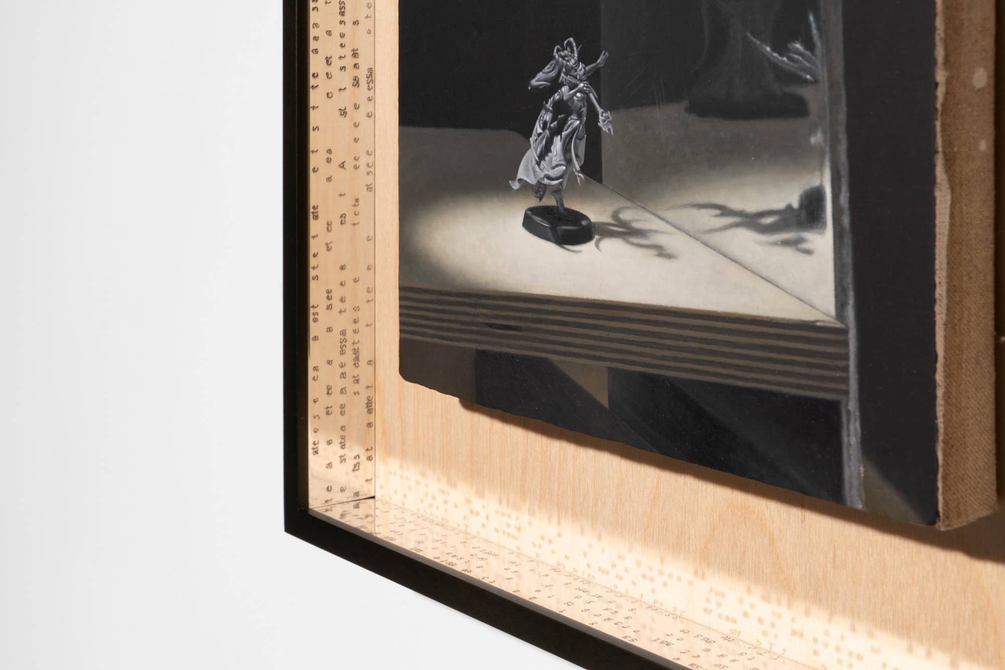 Detail of a small oil painting depicting a Warhammer model, spotlit, posed in front of a mirror, standing on a plywood board framed in custom black frame with plywood mat and polished aluminum interior border, engraved with the letters "T,A,S,T,E" repeating.